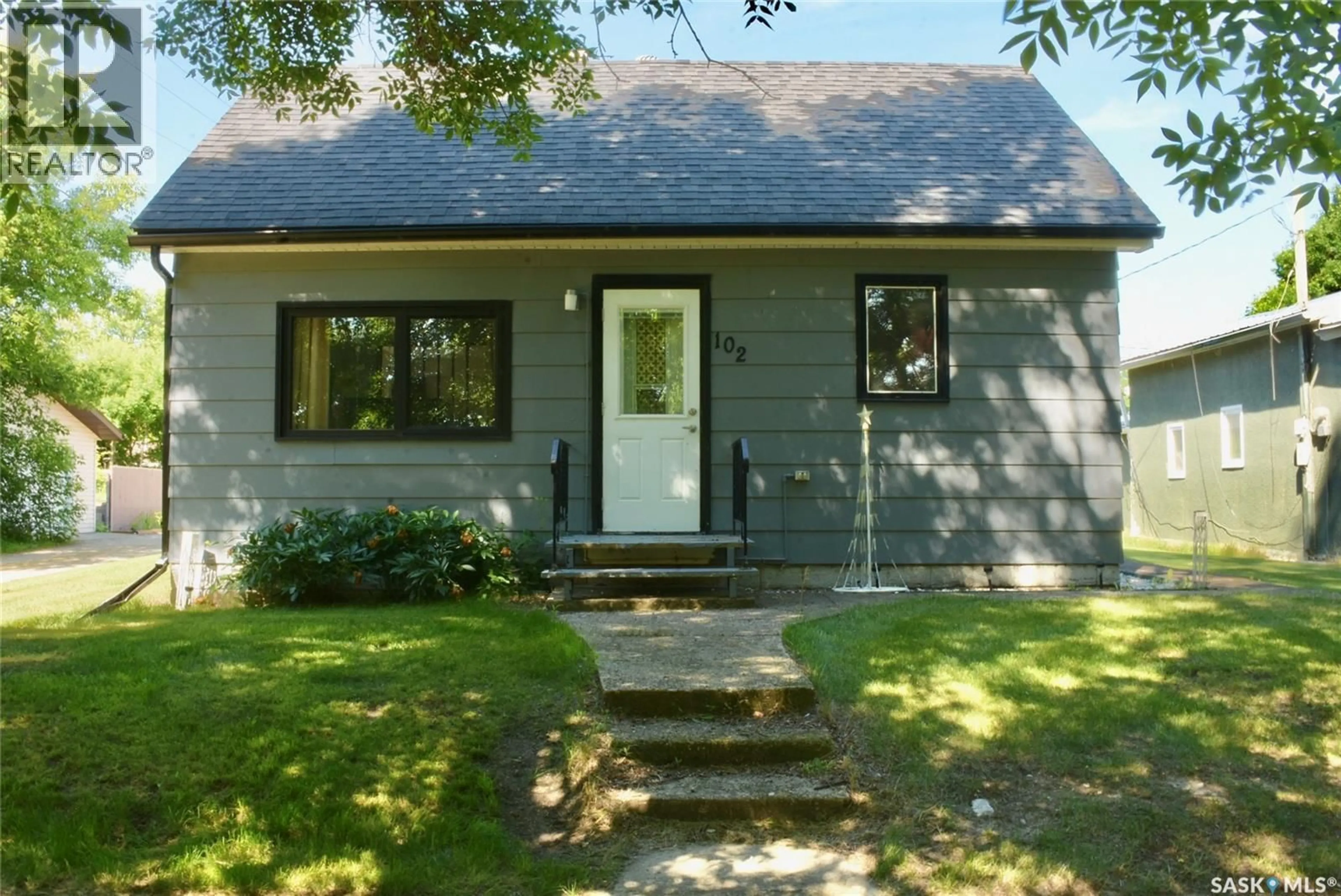Home with vinyl exterior material, street for 102 MCKENDRE STREET, Dysart Saskatchewan S0G1H0
