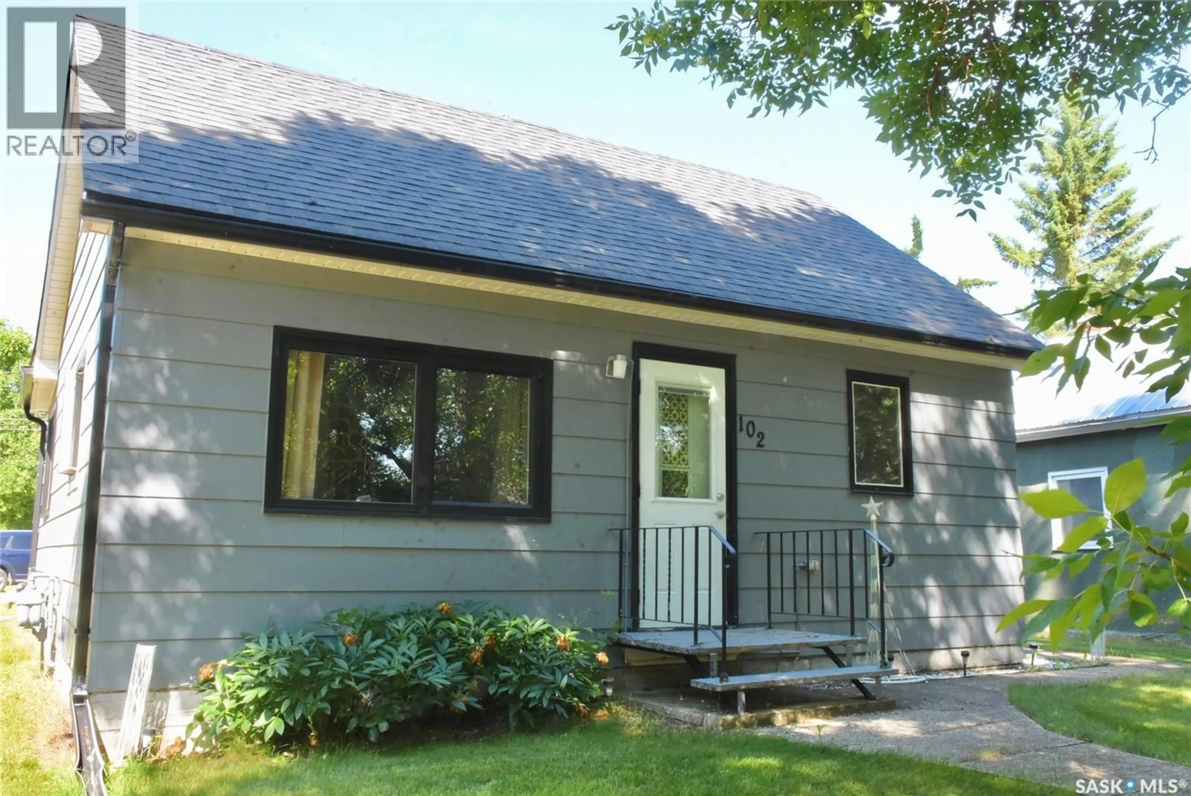 Home with vinyl exterior material, street for 102 MCKENDRE STREET, Dysart Saskatchewan S0G1H0