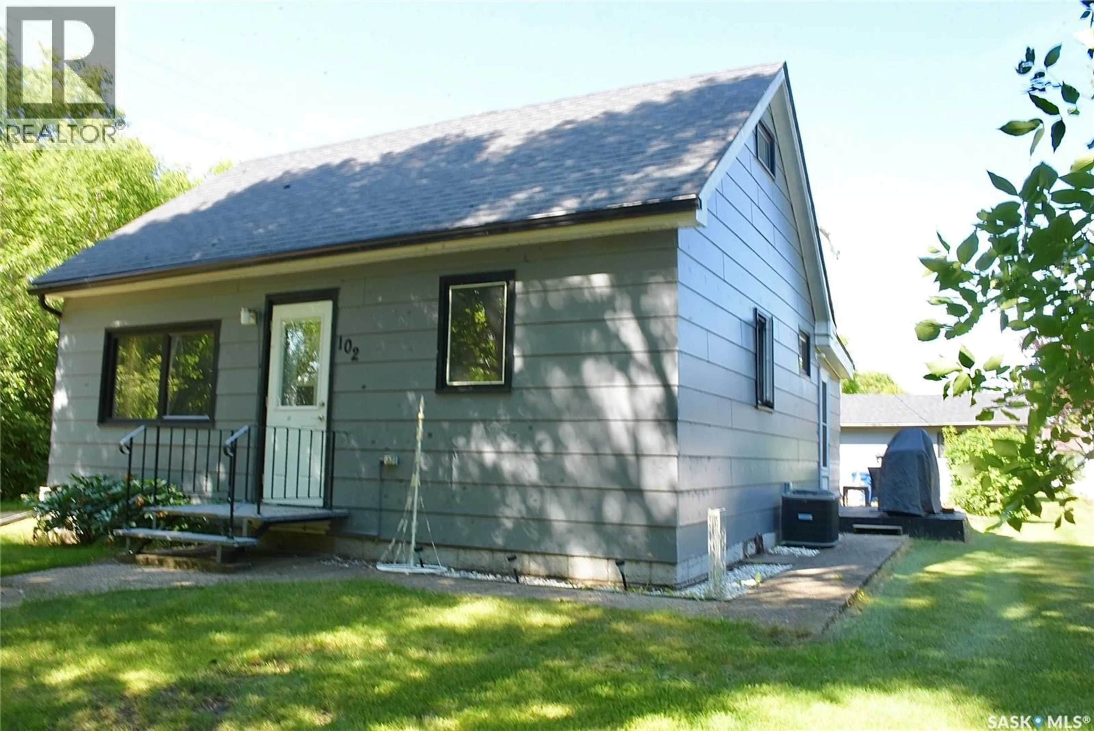 Home with vinyl exterior material, street for 102 MCKENDRE STREET, Dysart Saskatchewan S0G1H0