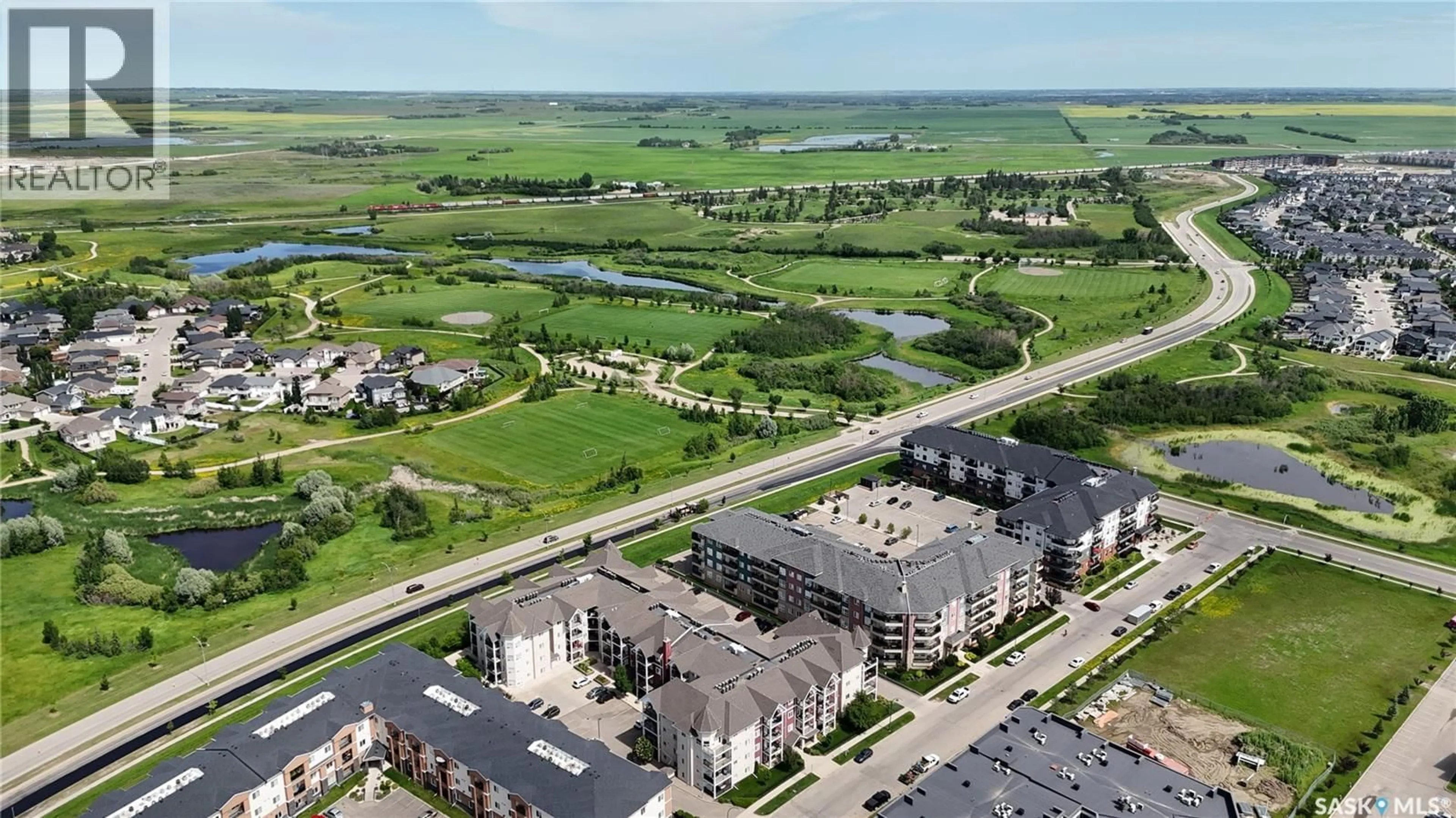A pic from outside/outdoor area/front of a property/back of a property/a pic from drone, water/lake/river/ocean view for 404 150 PAWLYCHENKO LANE, Saskatoon Saskatchewan S7V0B4