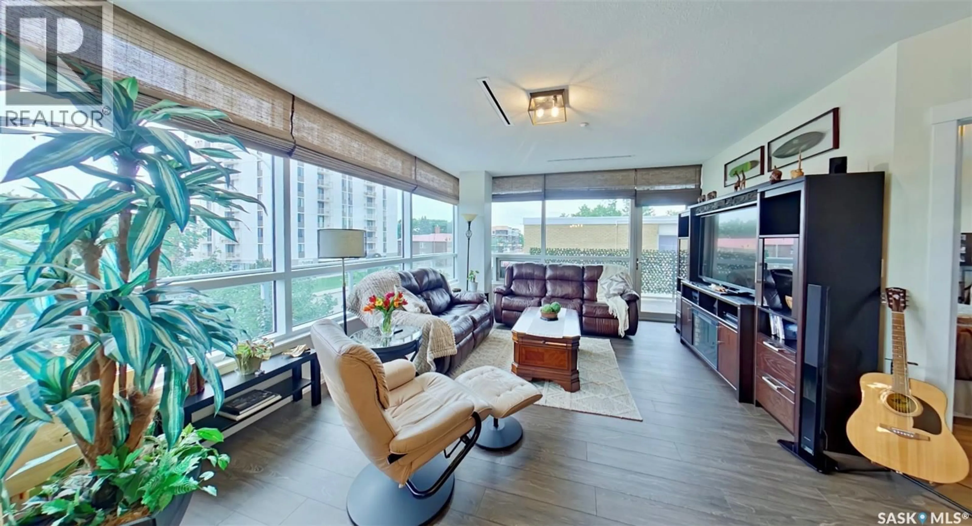 Living room with furniture, wood/laminate floor for 204 - 2300 BROAD STREET, Regina Saskatchewan S4P1Y8