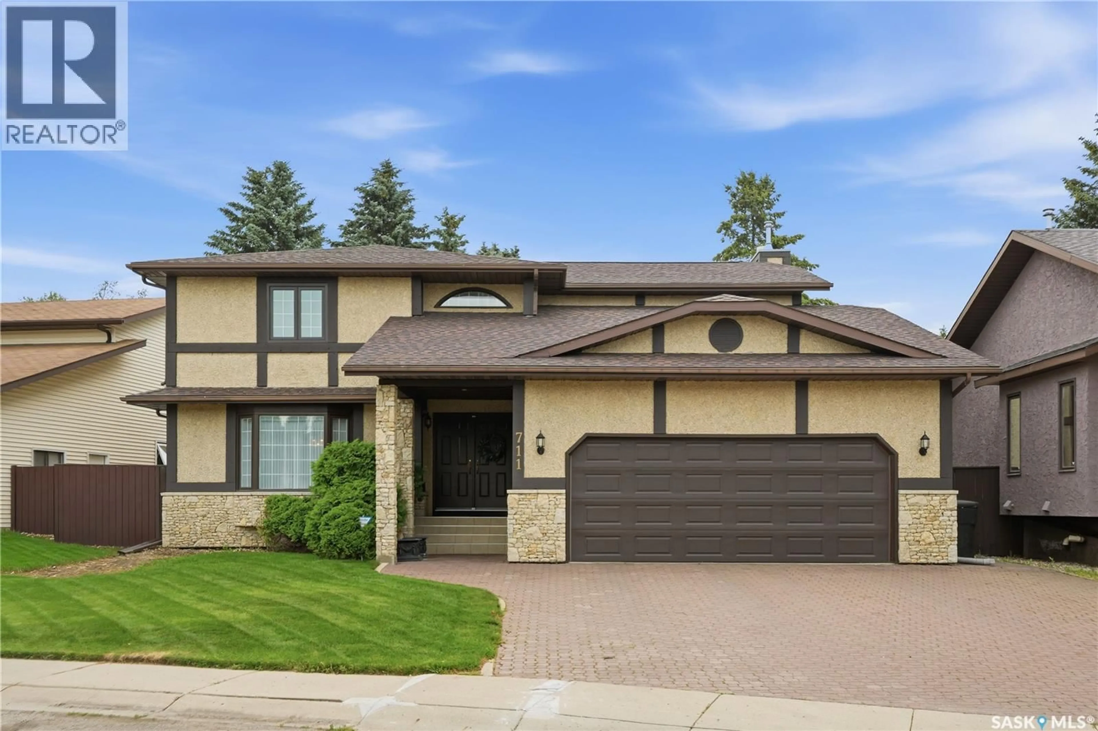 Home with brick exterior material, street for 711 WHITEWOOD COURT, Saskatoon Saskatchewan S7J4K5