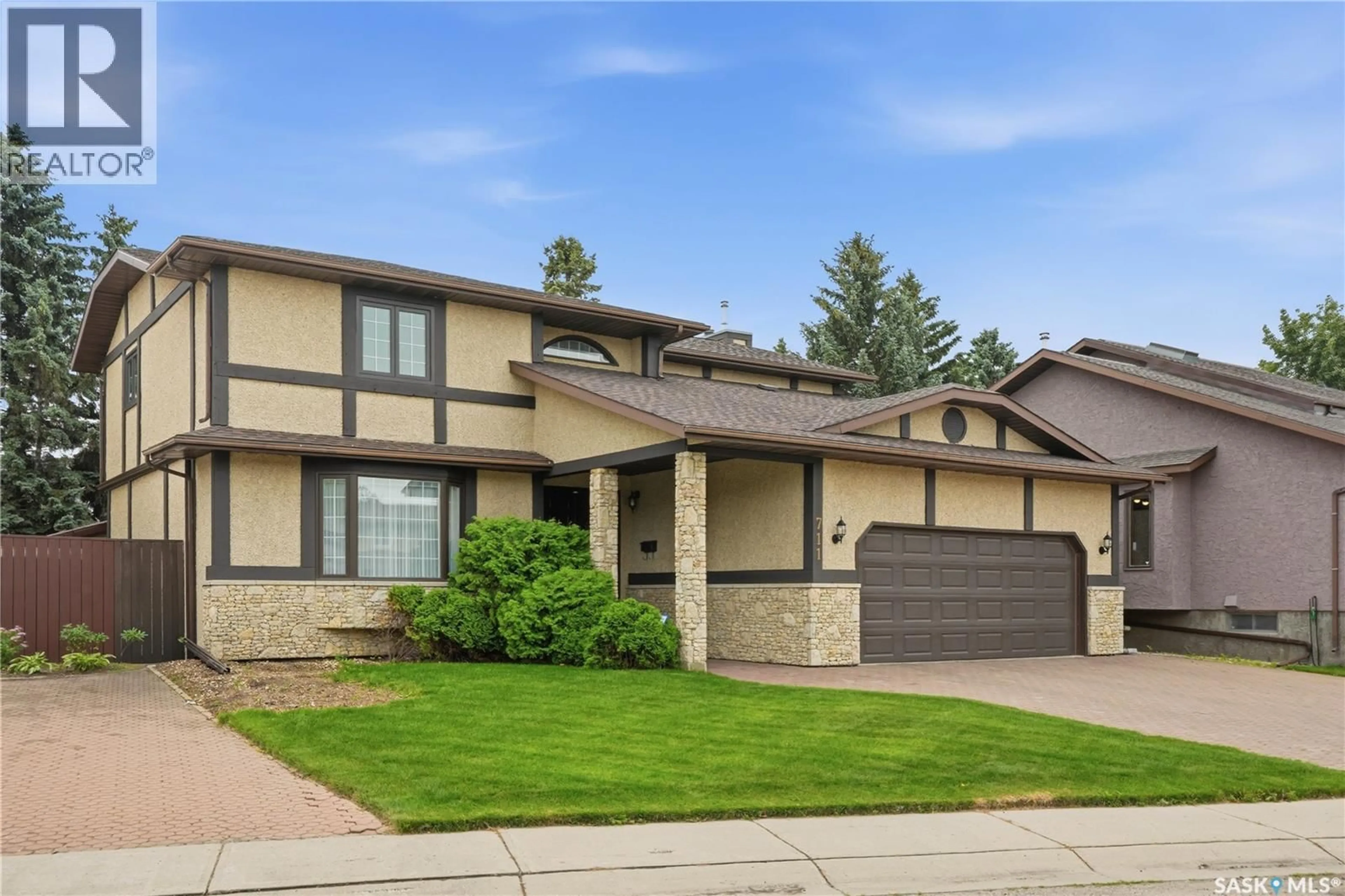 Home with brick exterior material, street for 711 WHITEWOOD COURT, Saskatoon Saskatchewan S7J4K5