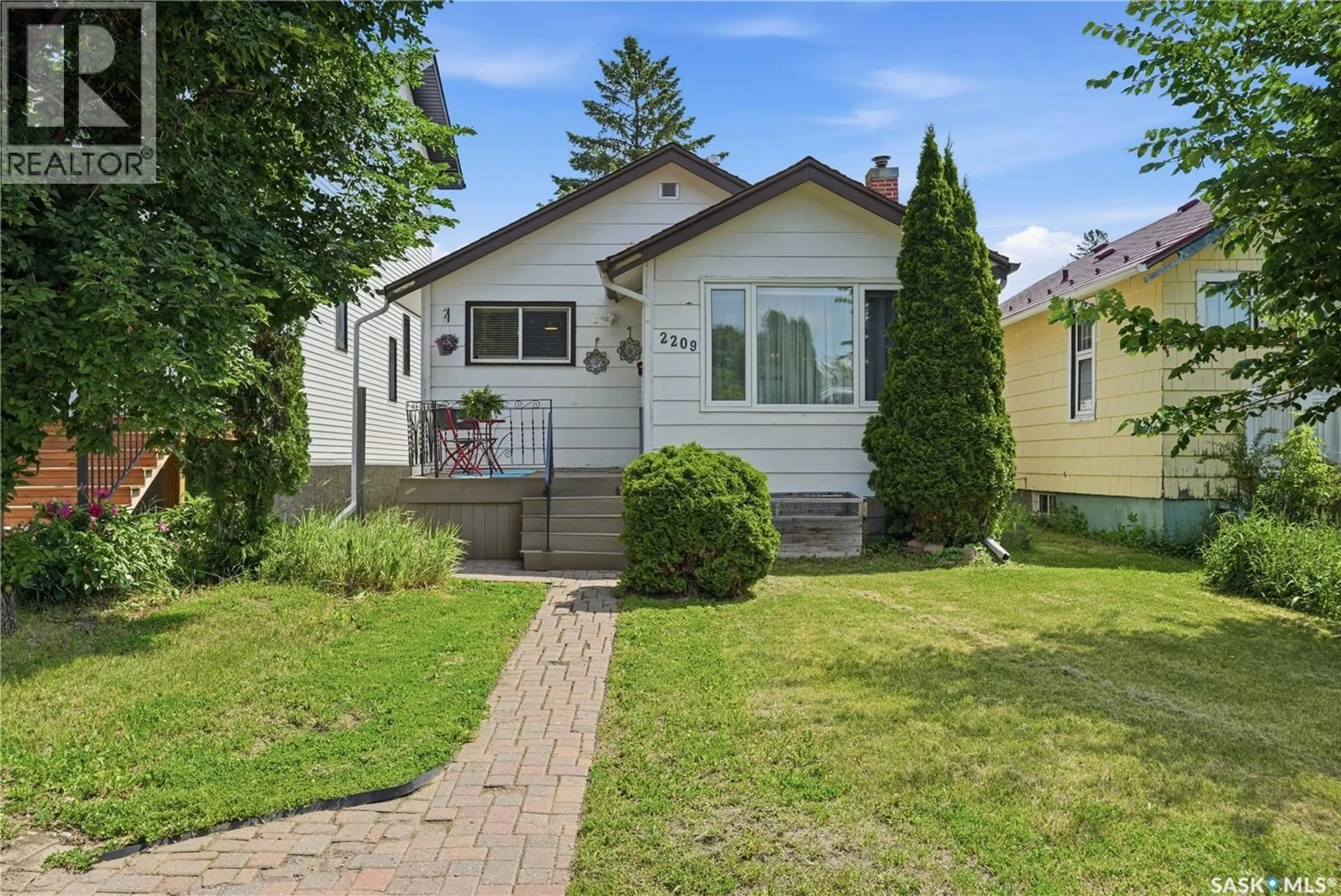 Home with vinyl exterior material, street for 2209 QUEEN STREET, Regina Saskatchewan S4T4C6