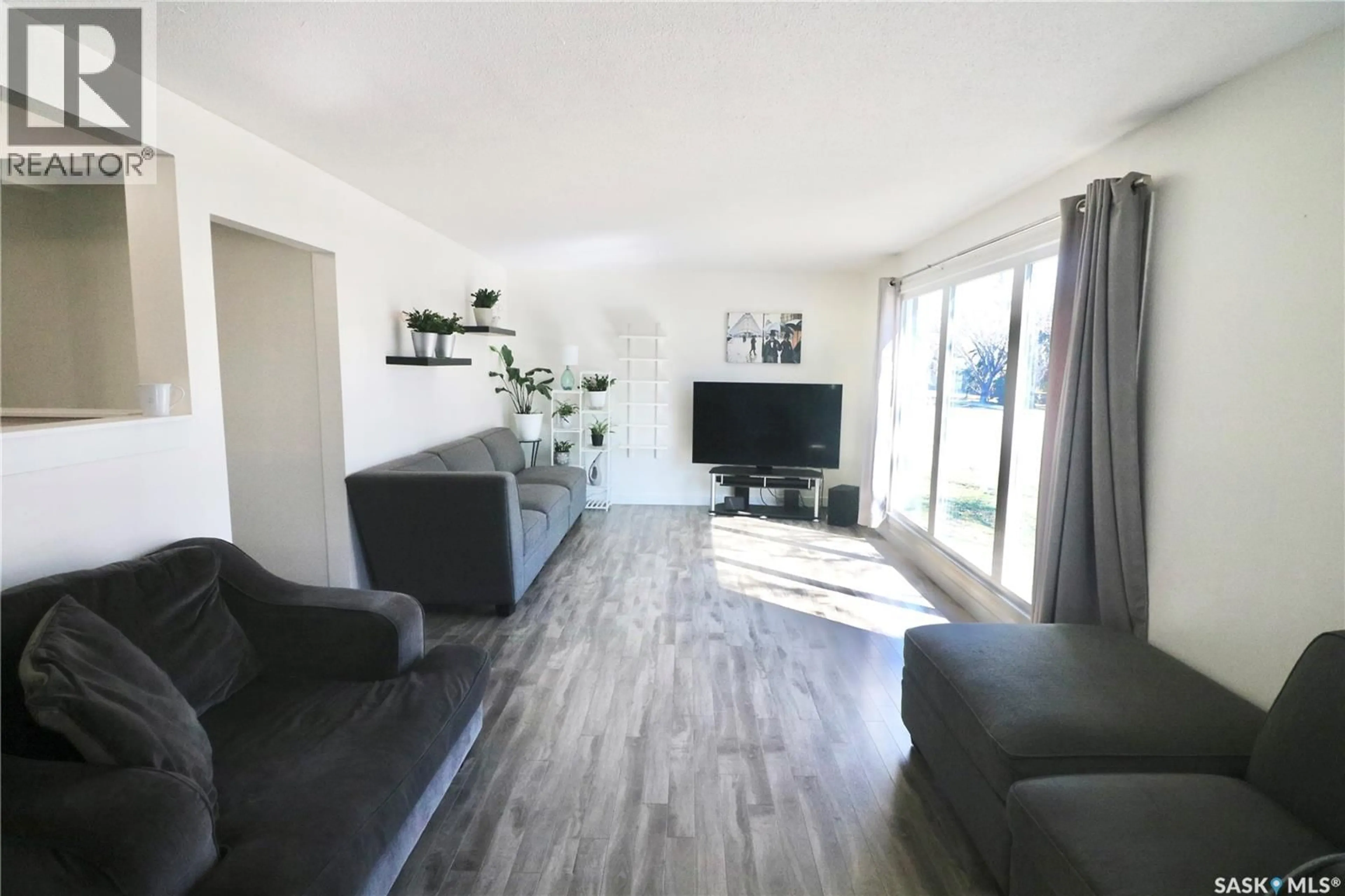 Living room with furniture, wood/laminate floor for 3920 MONTAGUE STREET, Regina Saskatchewan S4S3J5