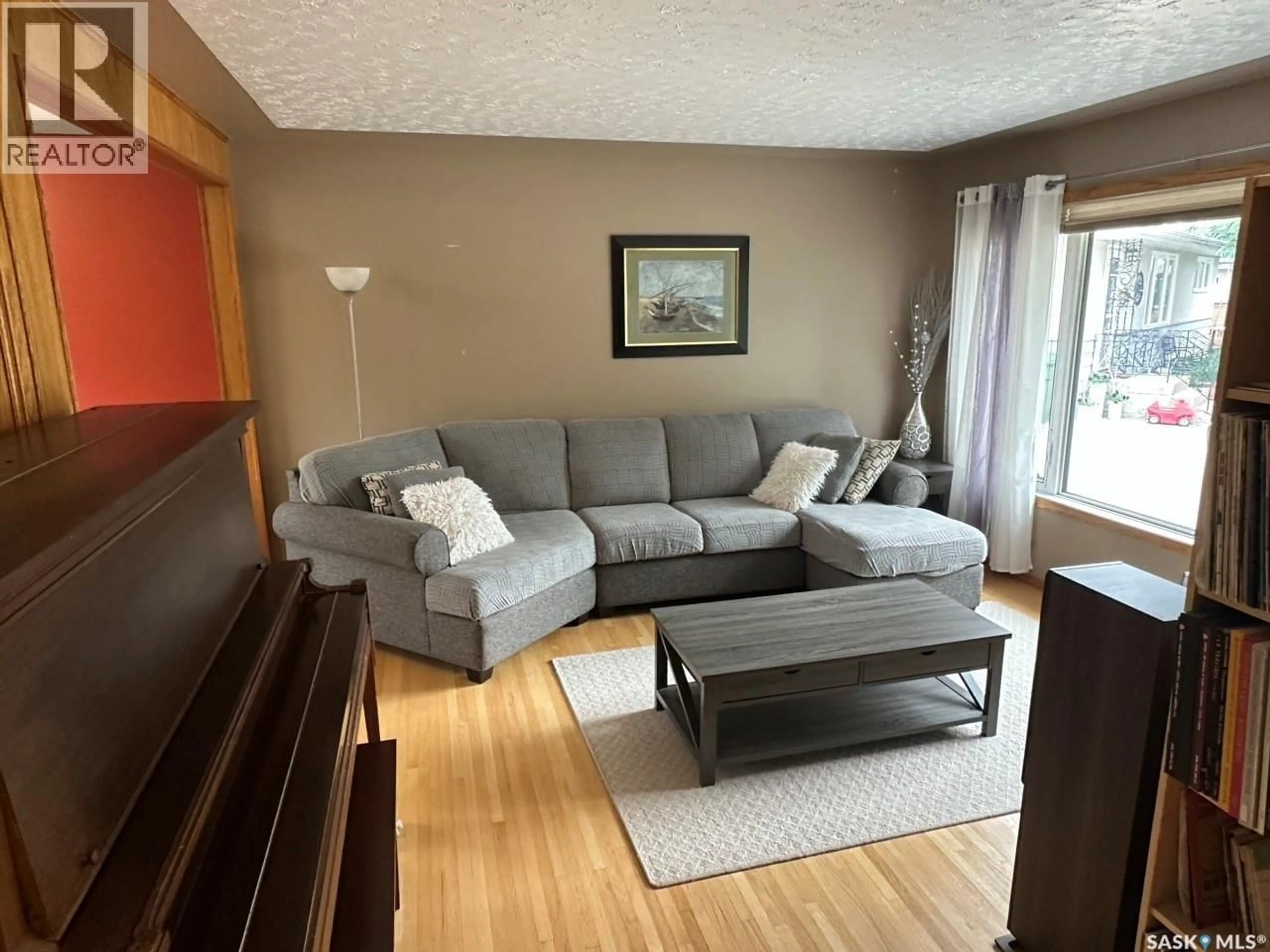 Living room with furniture, wood/laminate floor for 19 SAMPSON PLACE, Regina Saskatchewan S4R4R5