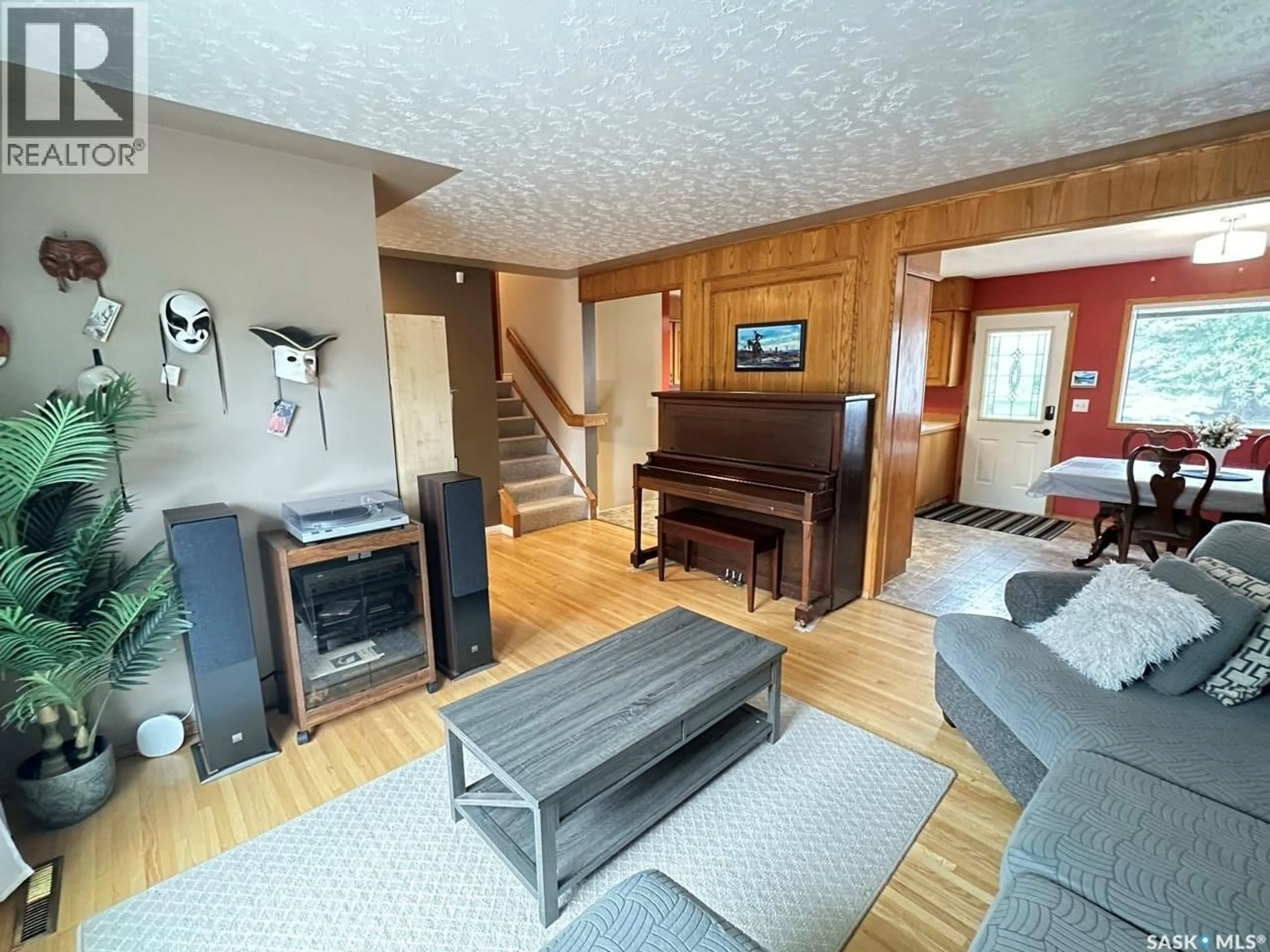 Living room with furniture, wood/laminate floor for 19 SAMPSON PLACE, Regina Saskatchewan S4R4R5