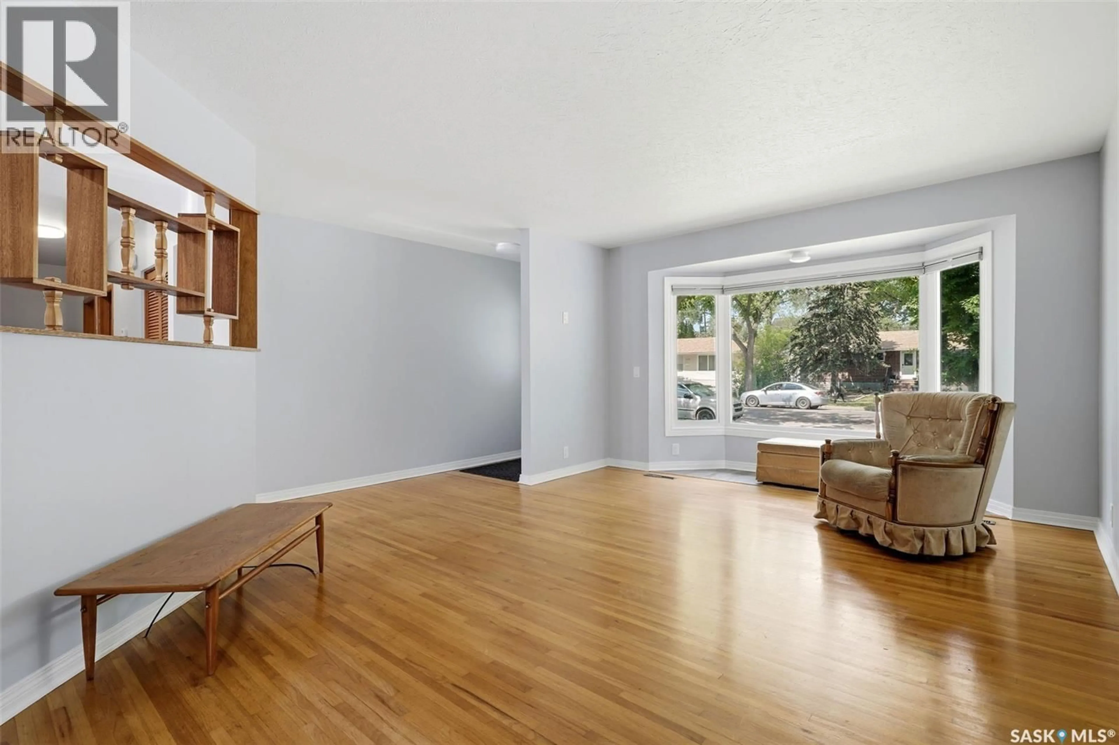 Living room with furniture, wood/laminate floor for 1631 MACPHERSON AVENUE, Regina Saskatchewan S4S4E1