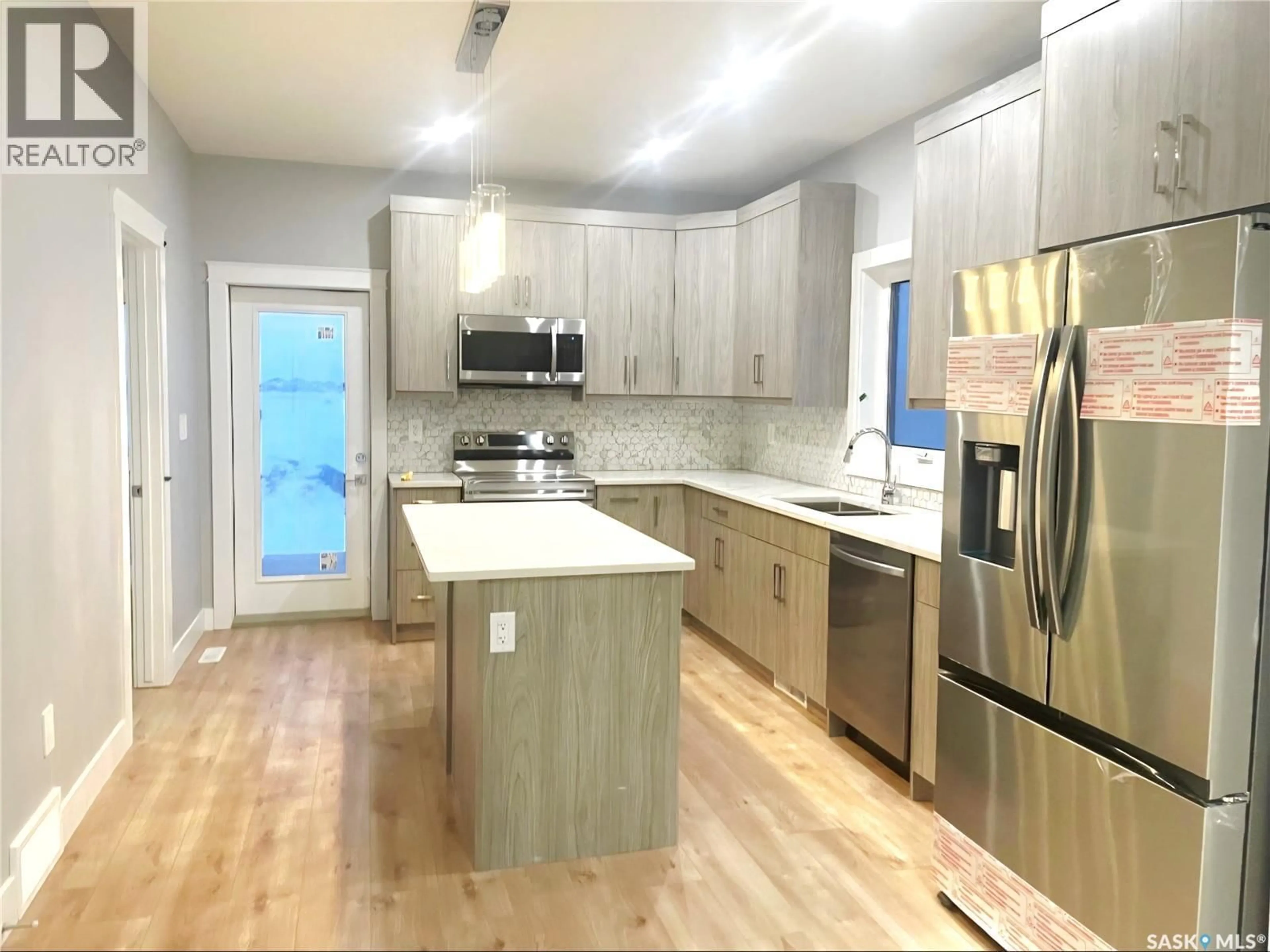Open concept kitchen, wood/laminate floor for 226 NIGHTINGALE ROAD, Saskatoon Saskatchewan S7L6Y1