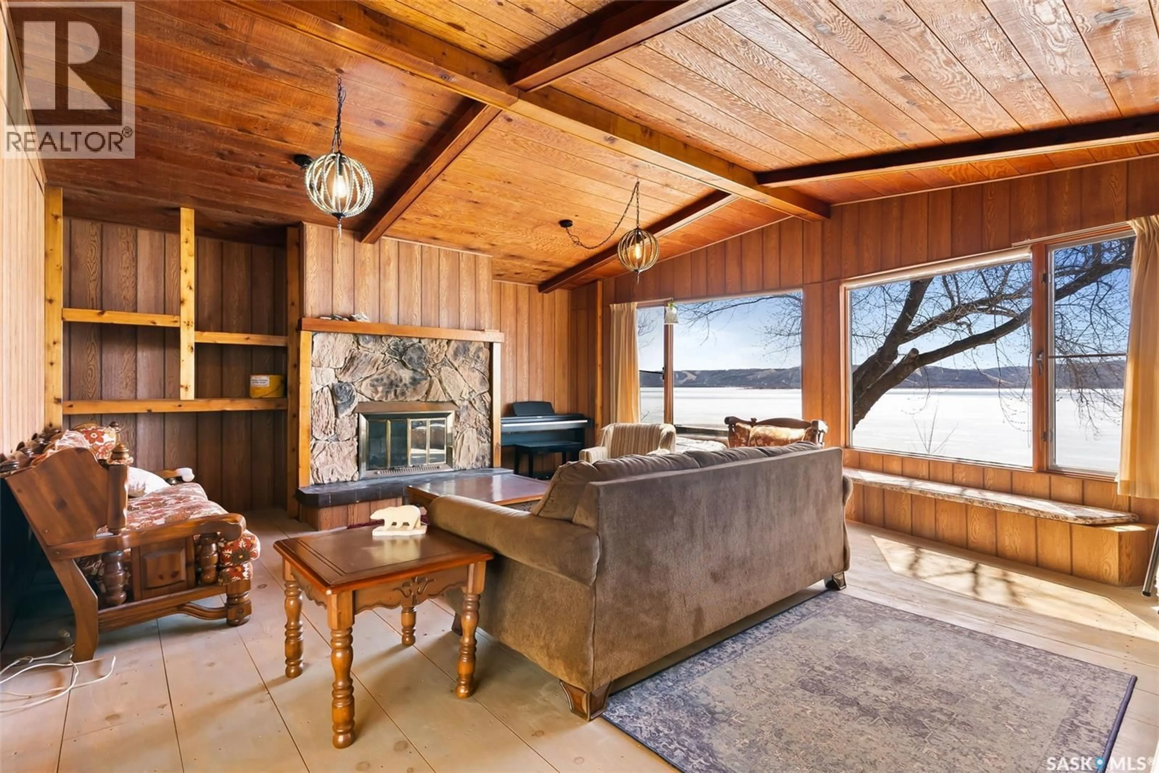 Living room with furniture, wood/laminate floor for 446 PASQUA LAKE ROAD, North Qu'Appelle Rm No. 187 Saskatchewan S0G1S0