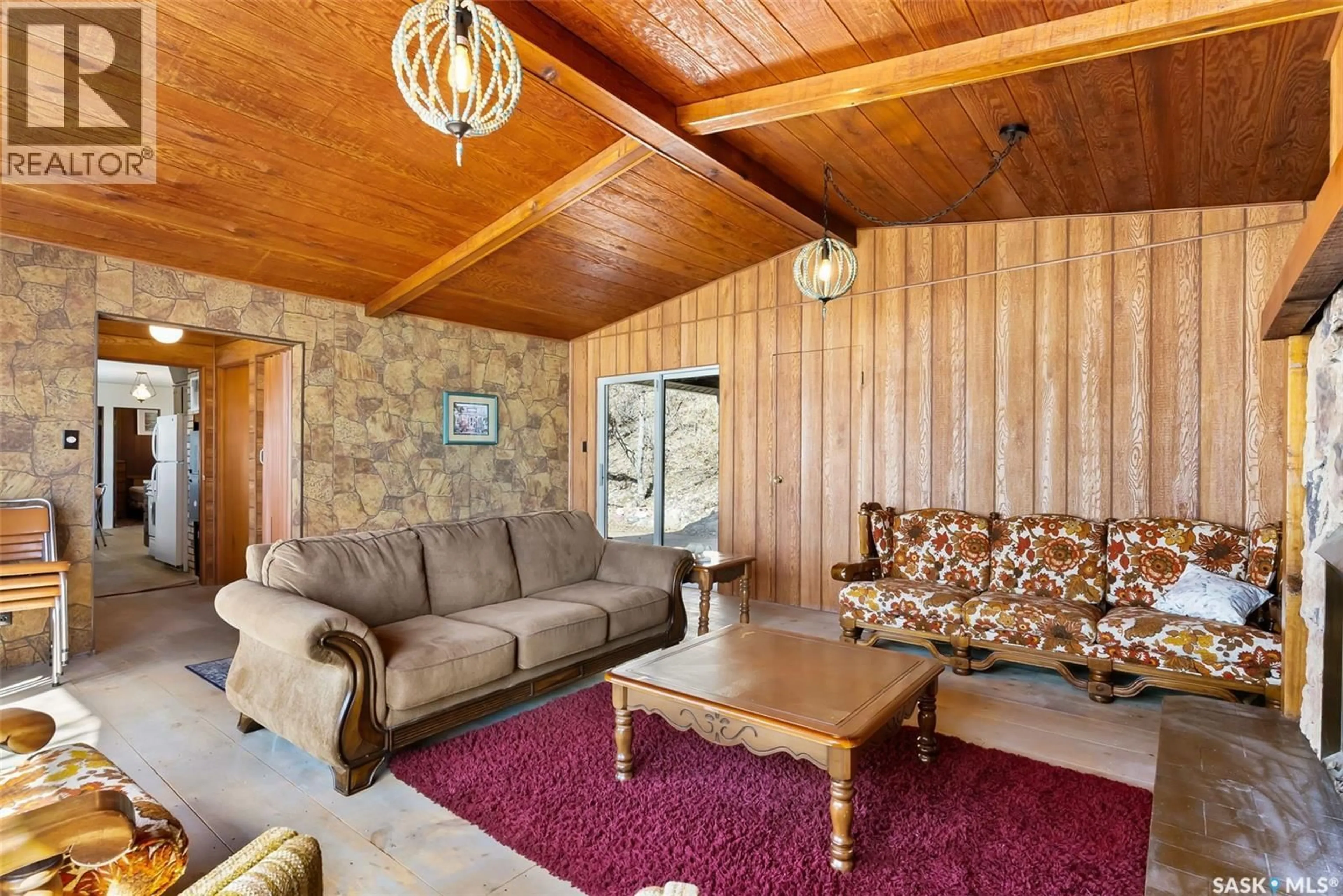 Living room with furniture, wood/laminate floor for 446 PASQUA LAKE ROAD, North Qu'Appelle Rm No. 187 Saskatchewan S0G1S0