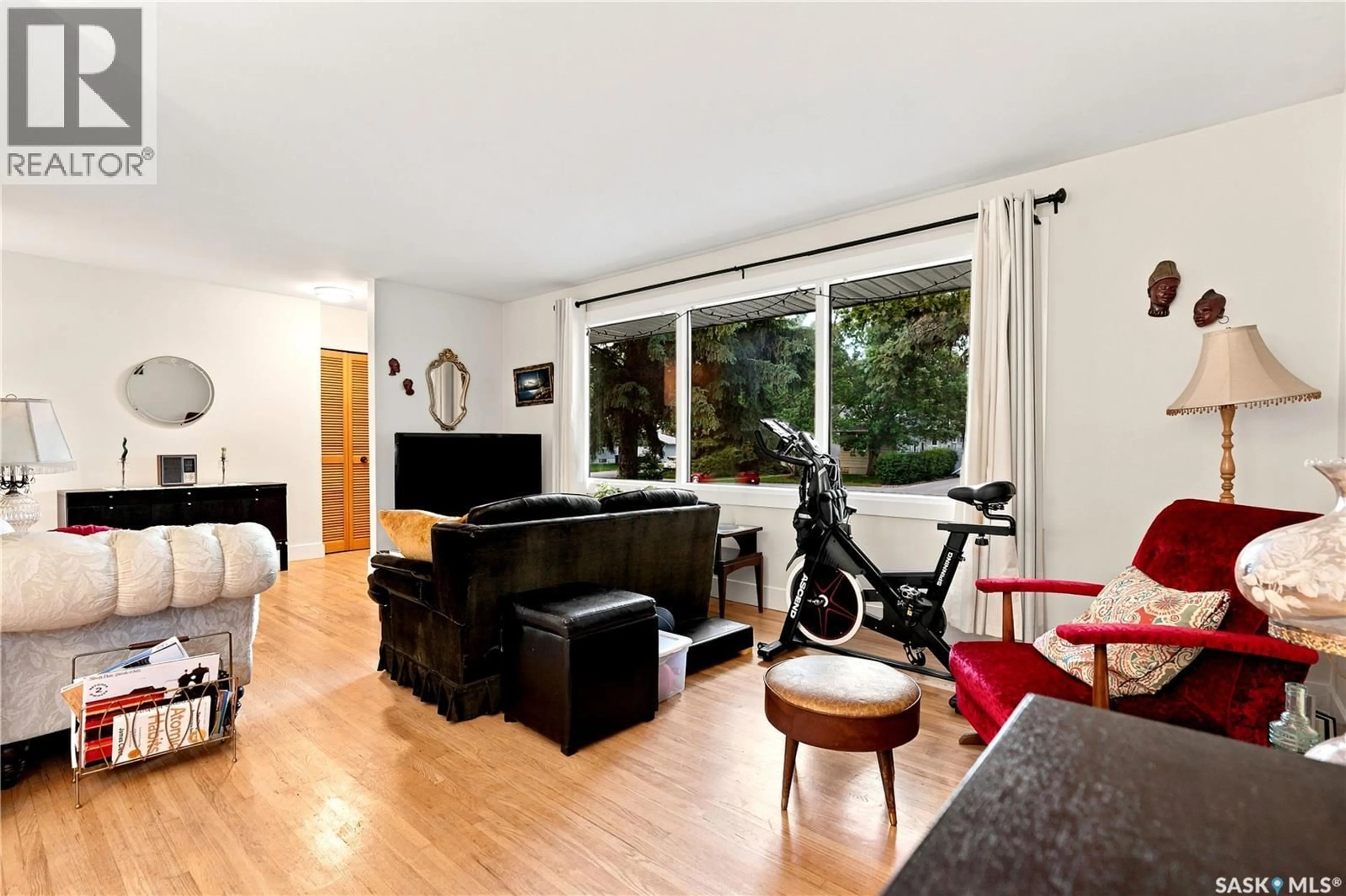 Living room with furniture, wood/laminate floor for 1706 EWART AVENUE, Saskatoon Saskatchewan S7H2L2