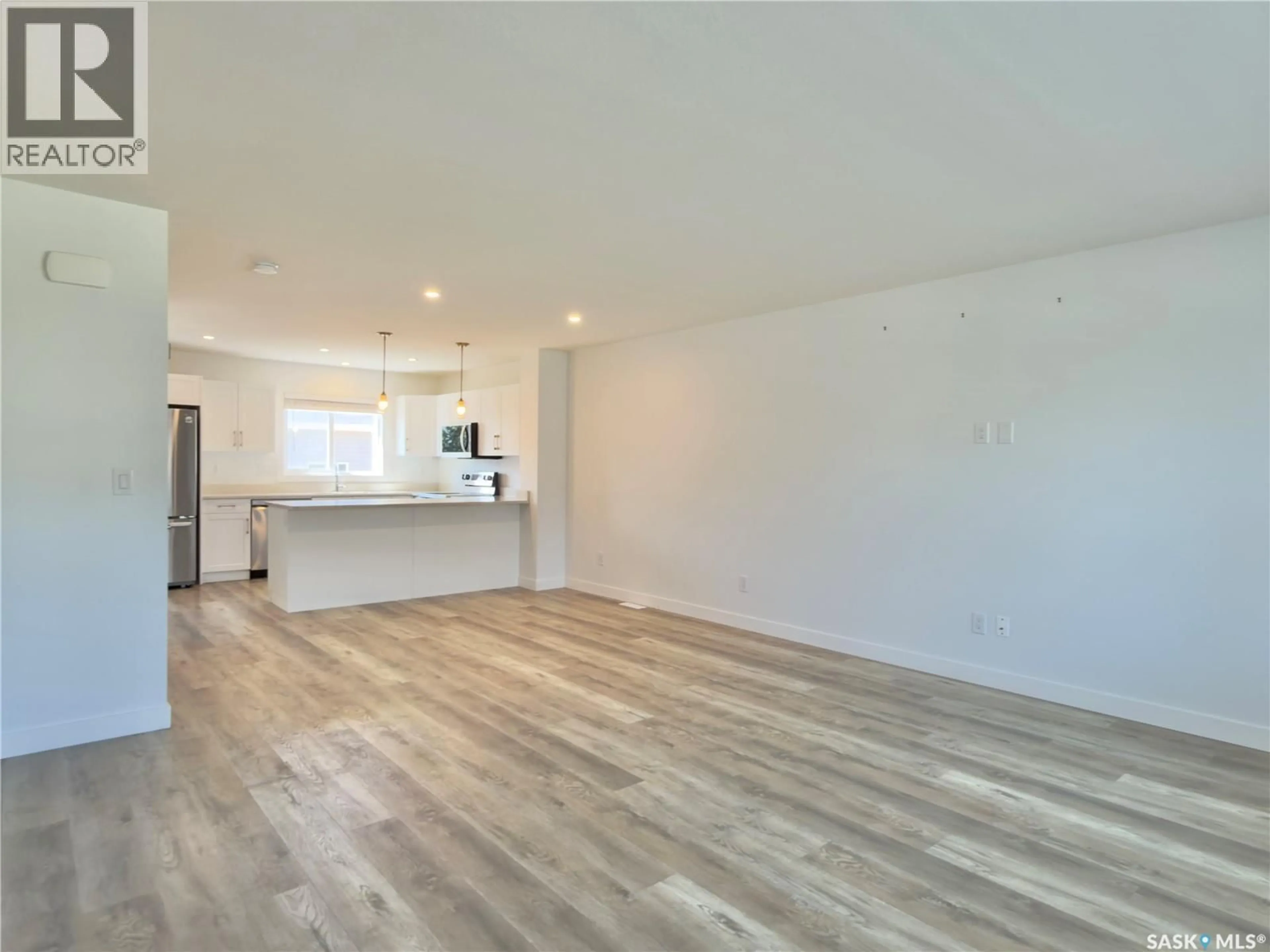 Open concept kitchen, wood/laminate floor for 128 WESTFIELD ROAD, Saskatoon Saskatchewan S7V0Z9