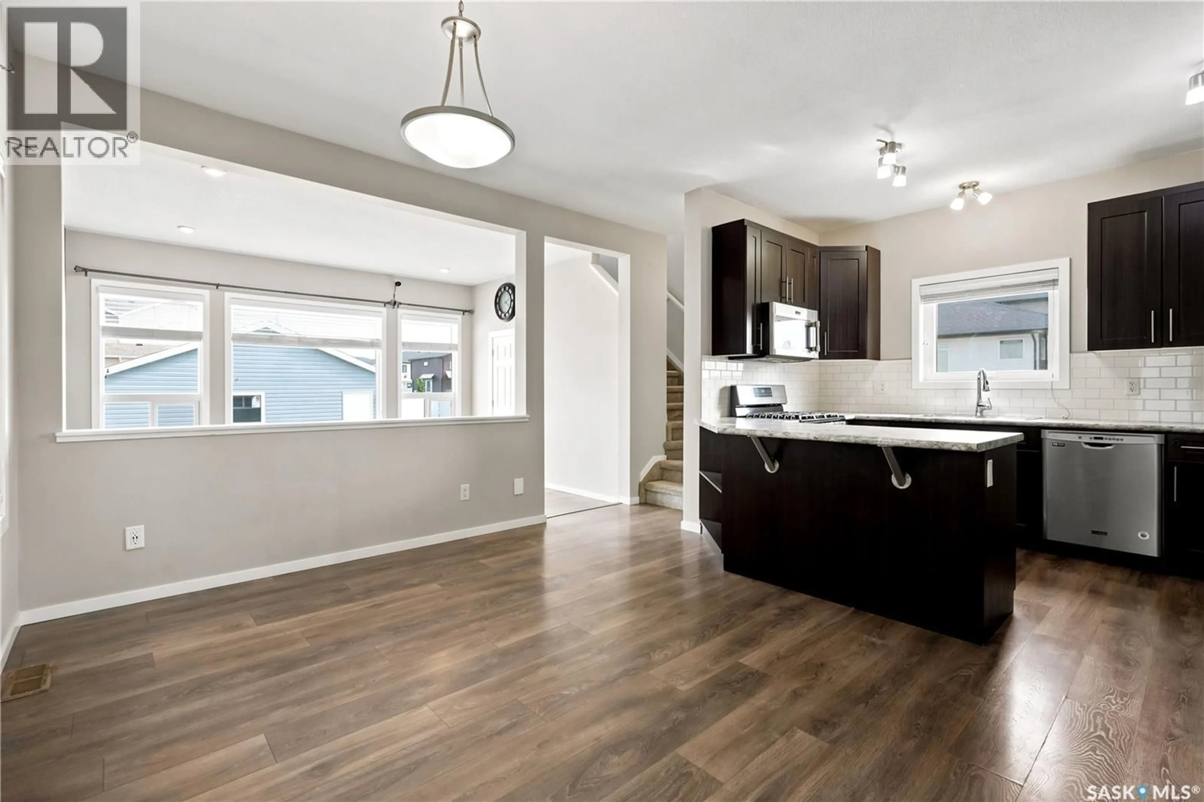 Open concept kitchen, wood/laminate floor for 2802 RIDGWAY AVENUE, Regina Saskatchewan S4X0N1