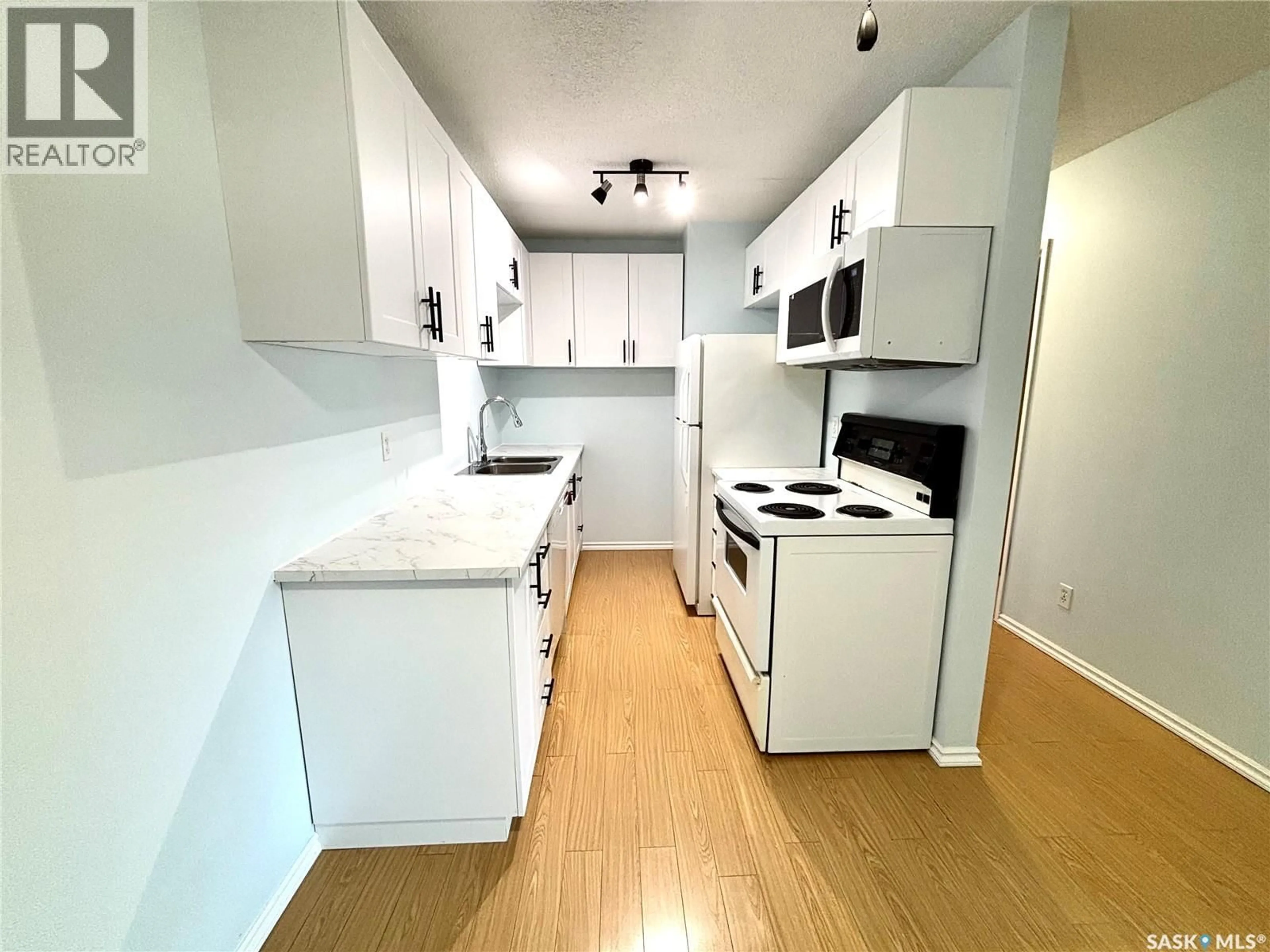 Standard kitchen, wood/laminate floor for 104 307 TAIT CRESCENT, Saskatoon Saskatchewan S7H5L6