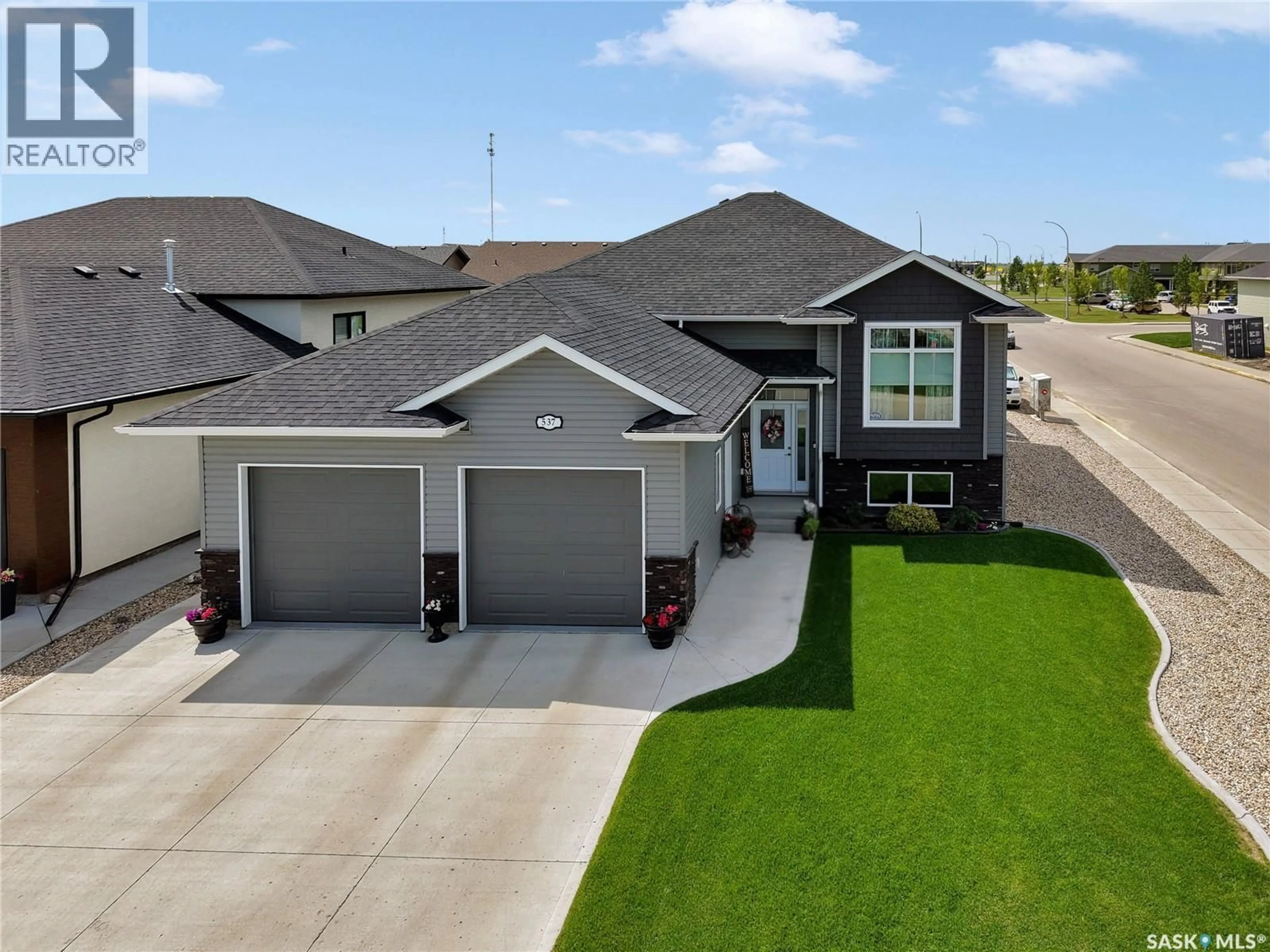 A pic from outside/outdoor area/front of a property/back of a property/a pic from drone, street for 537 MICKELSON LANE, Warman Saskatchewan S0K4S1
