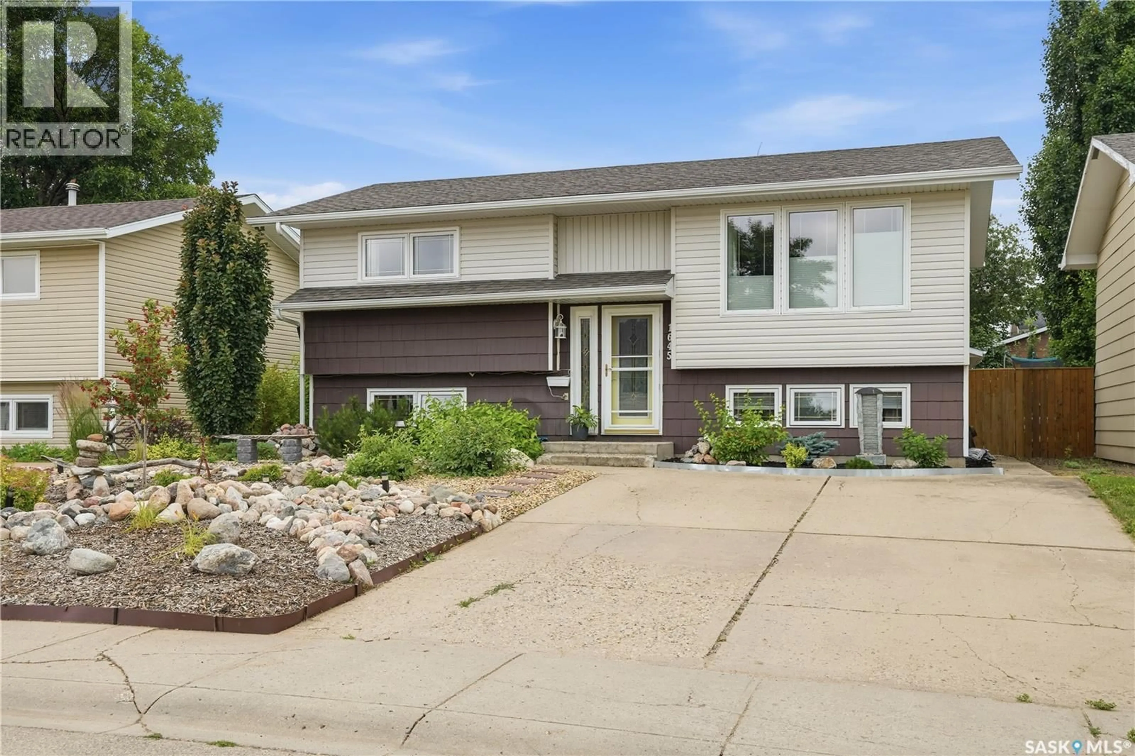 Home with vinyl exterior material, street for 1645 SMITH STREET, Moose Jaw Saskatchewan S6K1A7