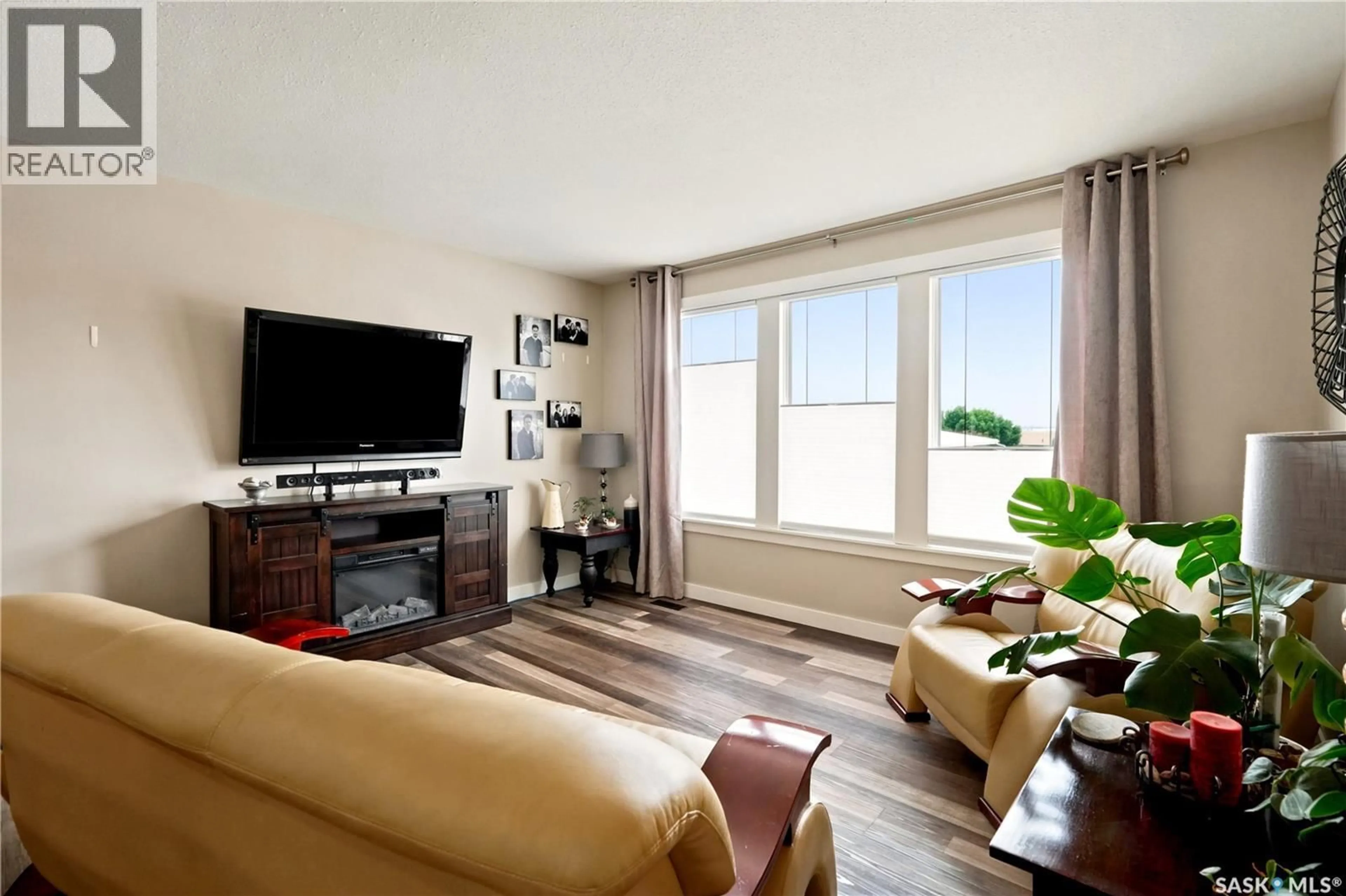 Living room with furniture, wood/laminate floor for 1645 SMITH STREET, Moose Jaw Saskatchewan S6K1A7