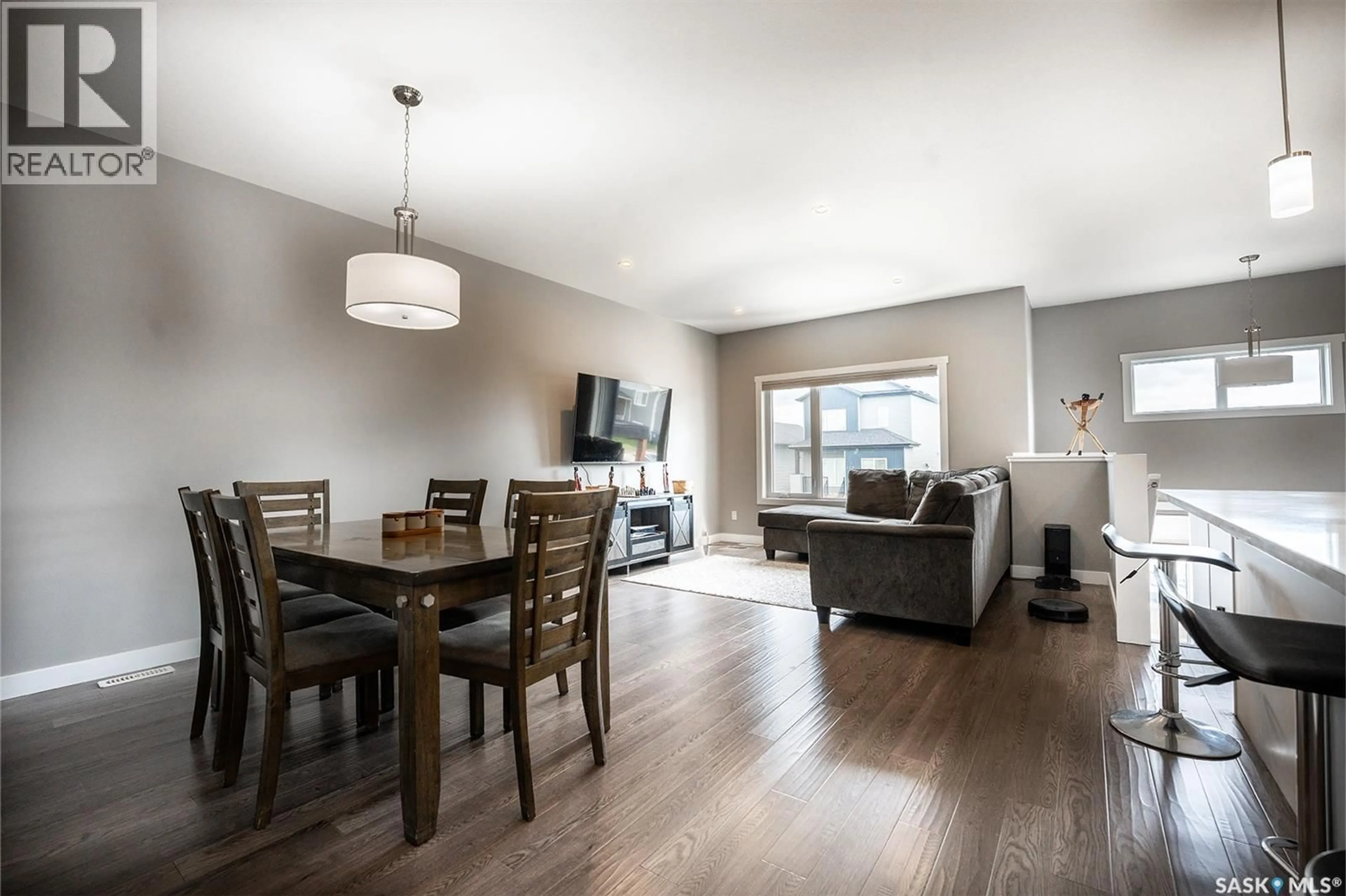 Living room with furniture, wood/laminate floor for 415 MCARTHUR CRESCENT, Saskatoon Saskatchewan S7L6Y3