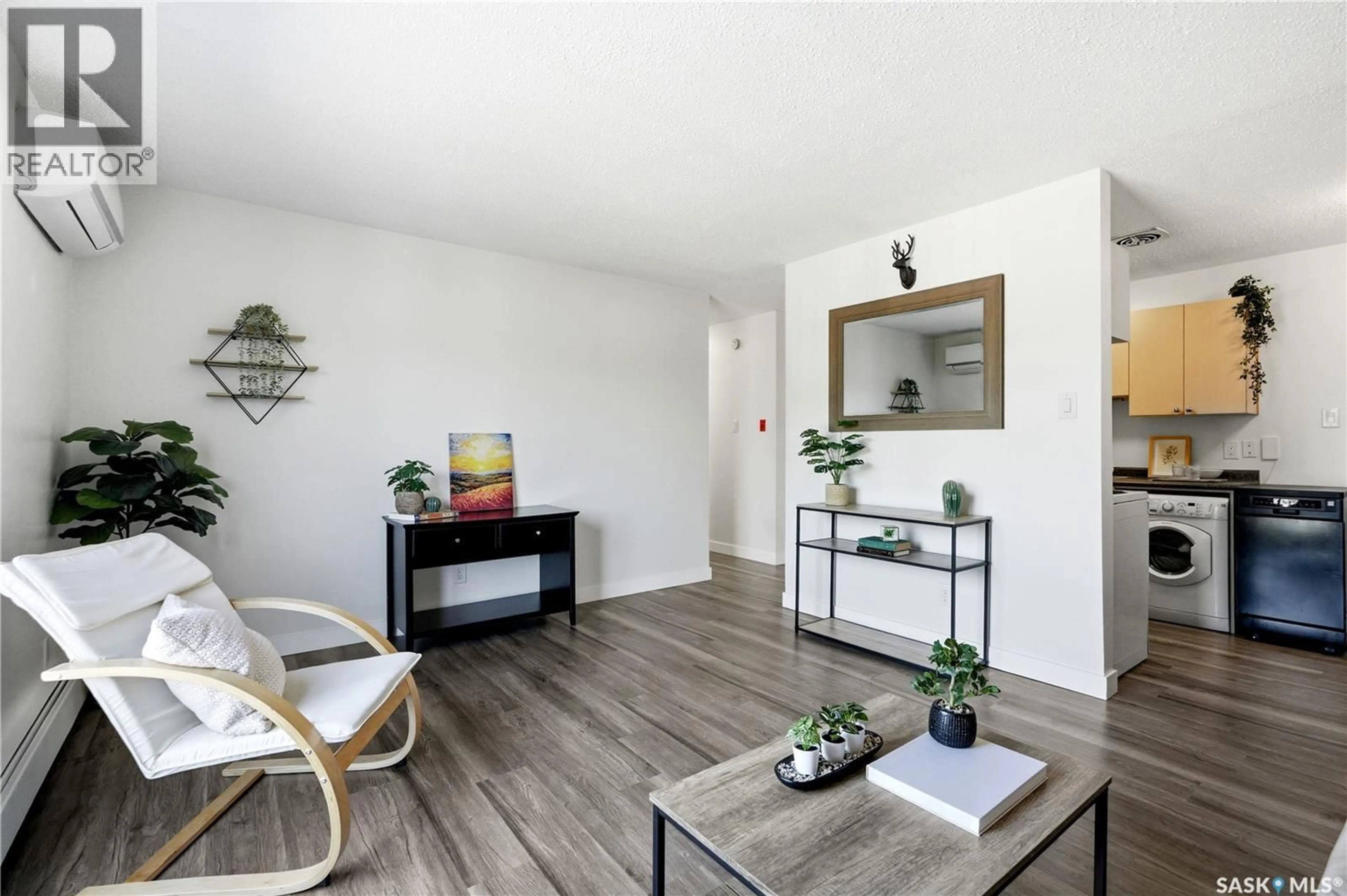 Living room with furniture, wood/laminate floor for 16 116 ACADIA COURT, Saskatoon Saskatchewan S7H4T7