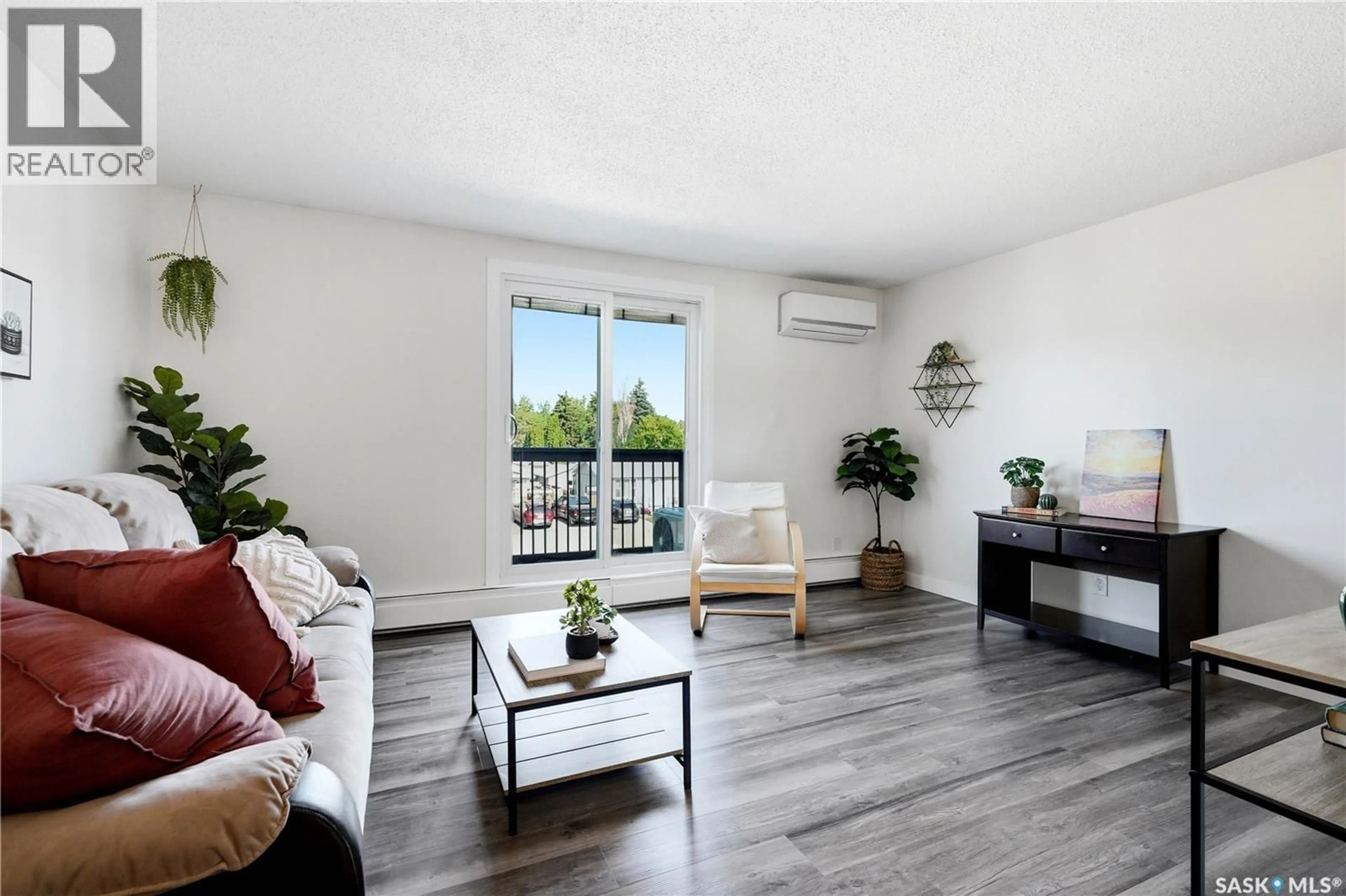Living room with furniture, wood/laminate floor for 16 116 ACADIA COURT, Saskatoon Saskatchewan S7H4T7