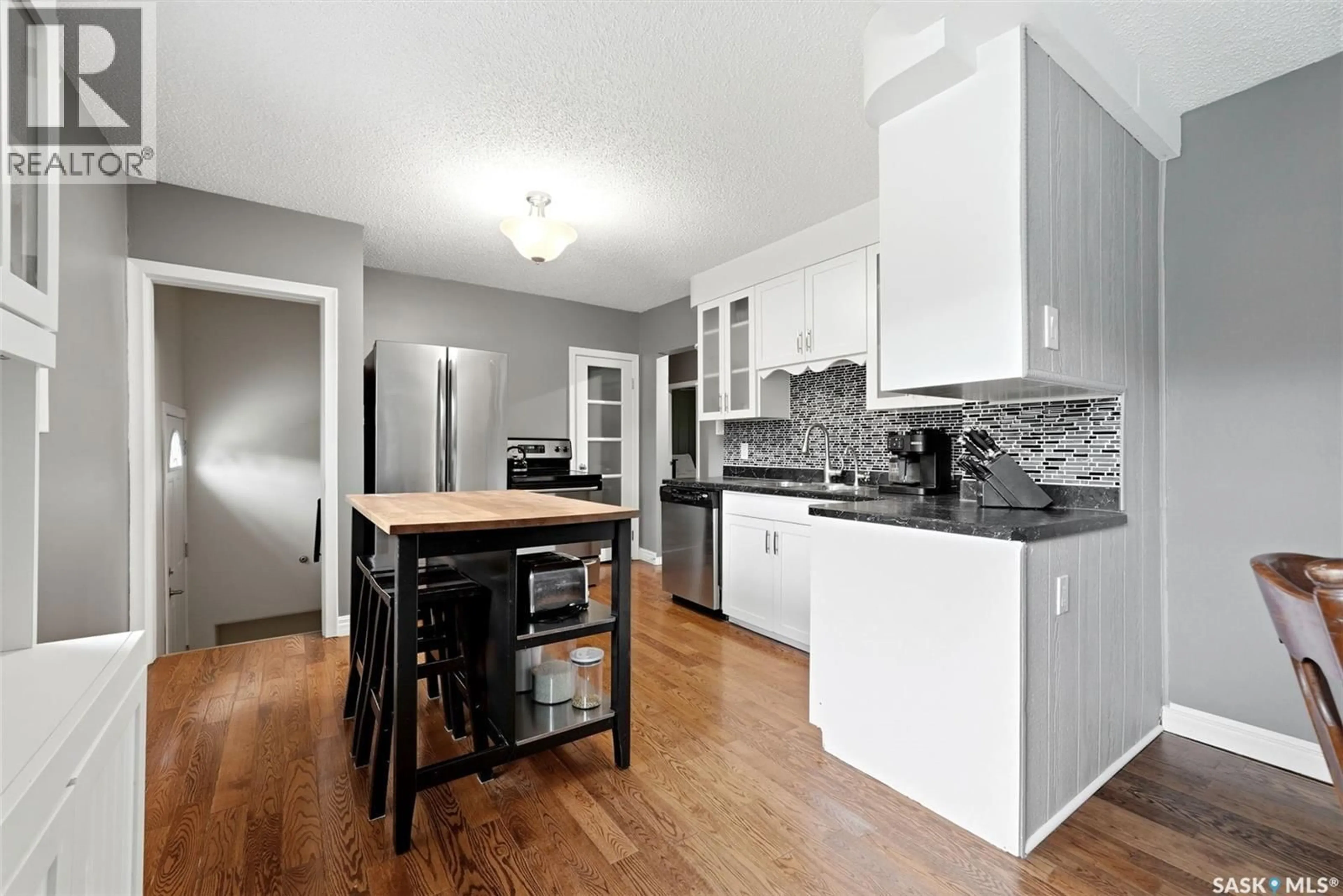 Open concept kitchen, wood/laminate floor for 408 MULLIN AVENUE, Regina Saskatchewan S4N1C7