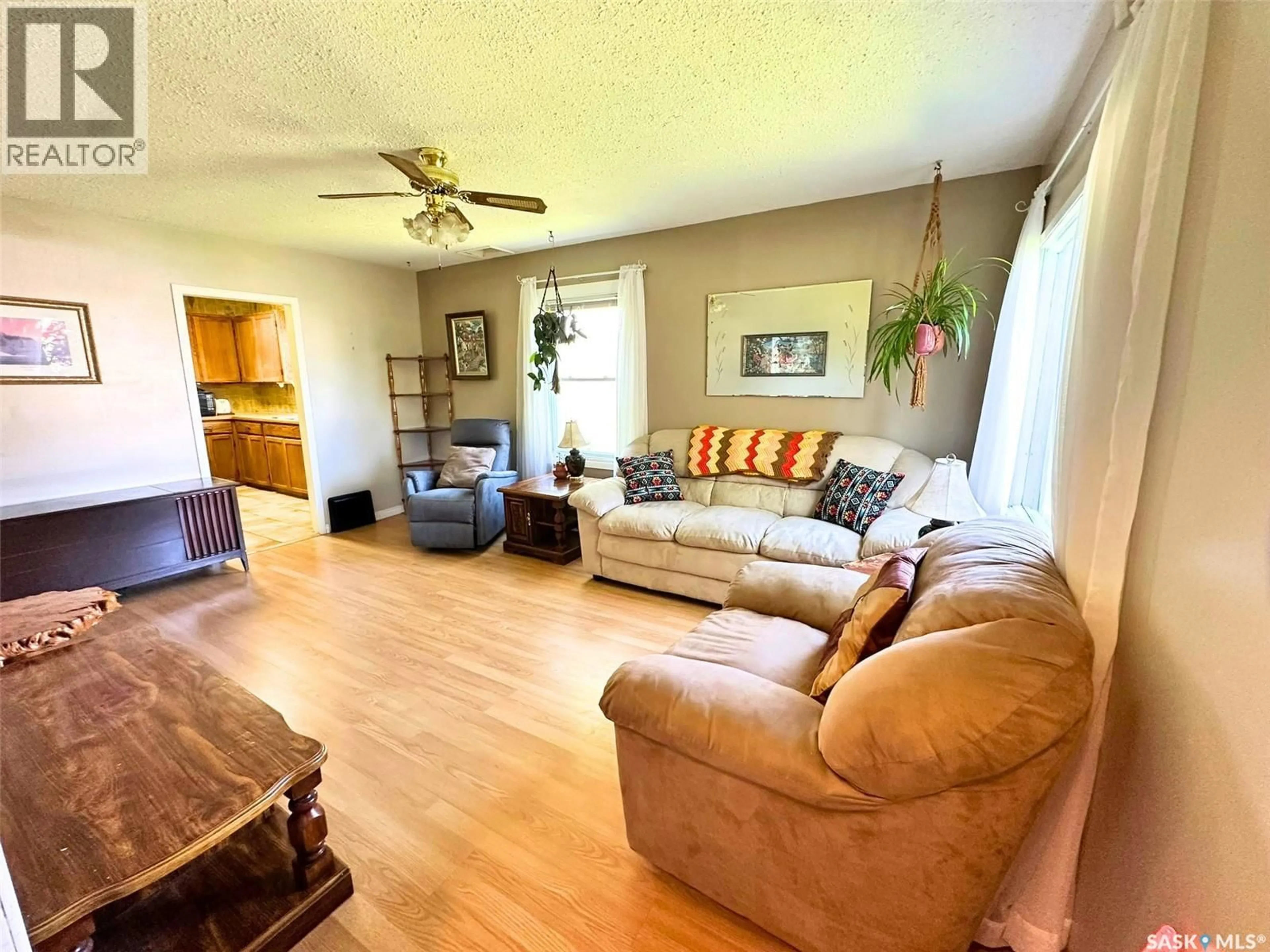 Living room with furniture, wood/laminate floor for 249 6TH STREET, Prince Albert Saskatchewan S6V0M9