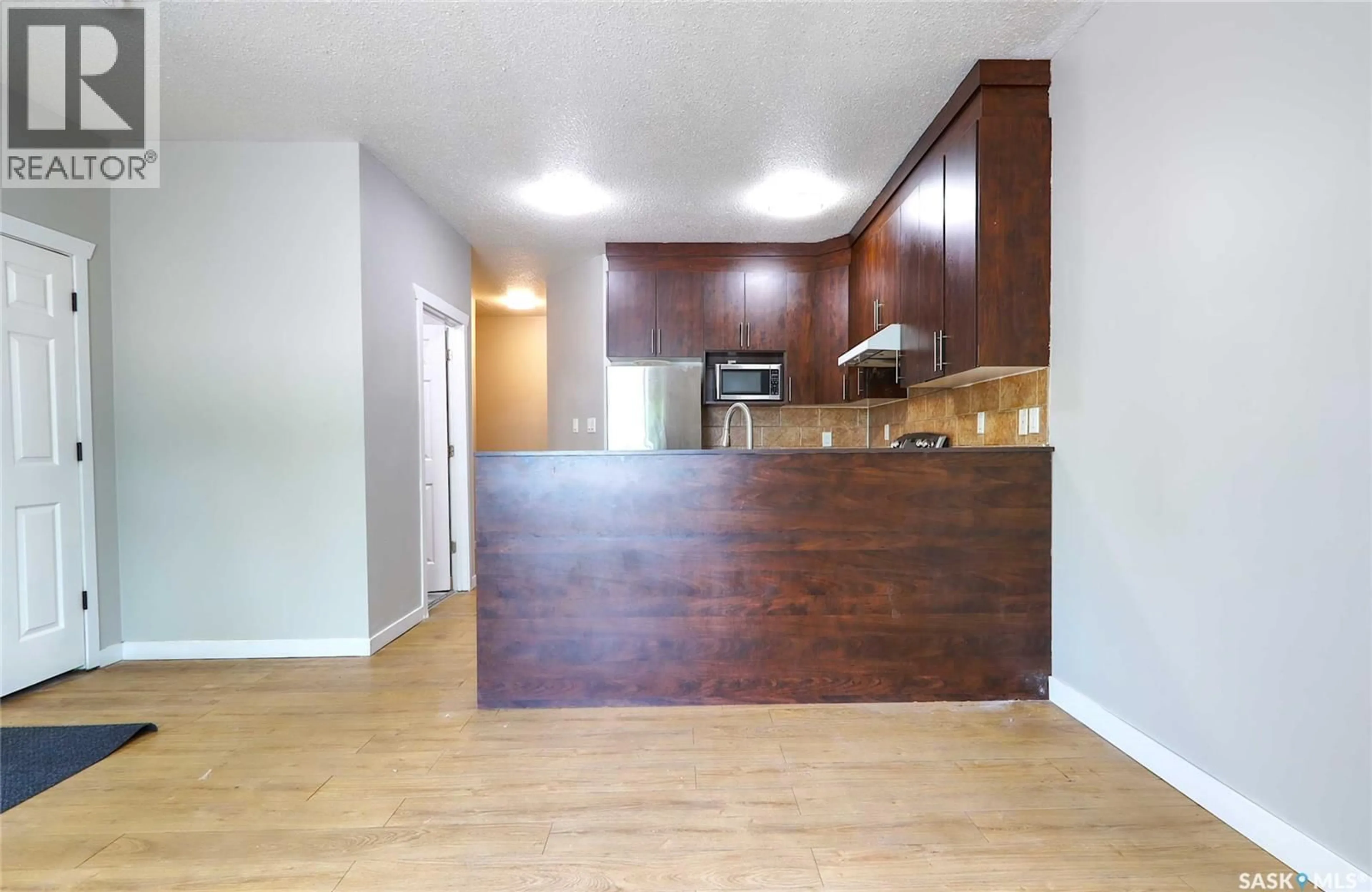Open concept kitchen, wood/laminate floor for 741 GARNET STREET, Regina Saskatchewan S4T2X2