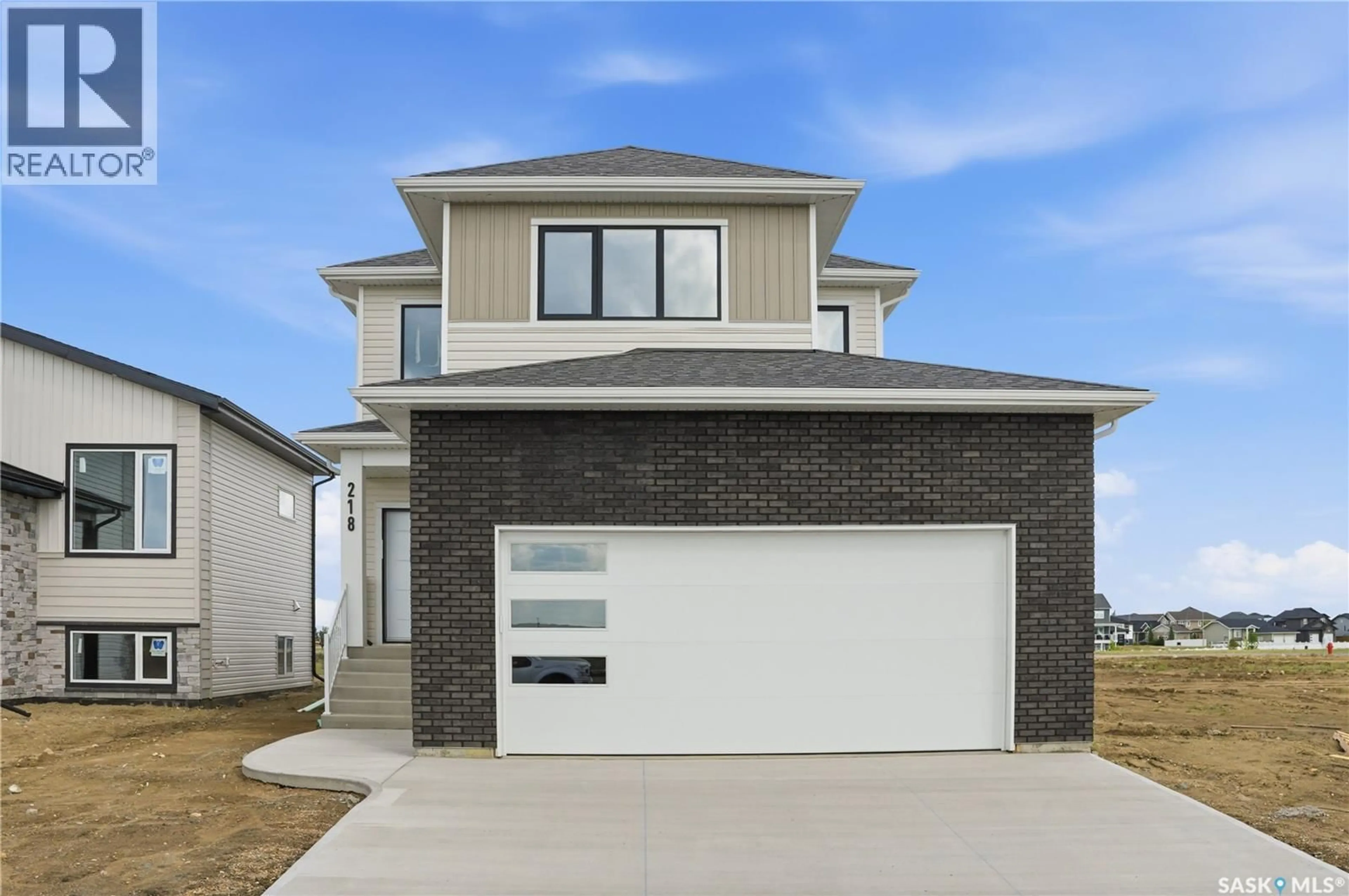 Home with brick exterior material, street for 218 VETERANS DRIVE, Warman Saskatchewan S0K0A1