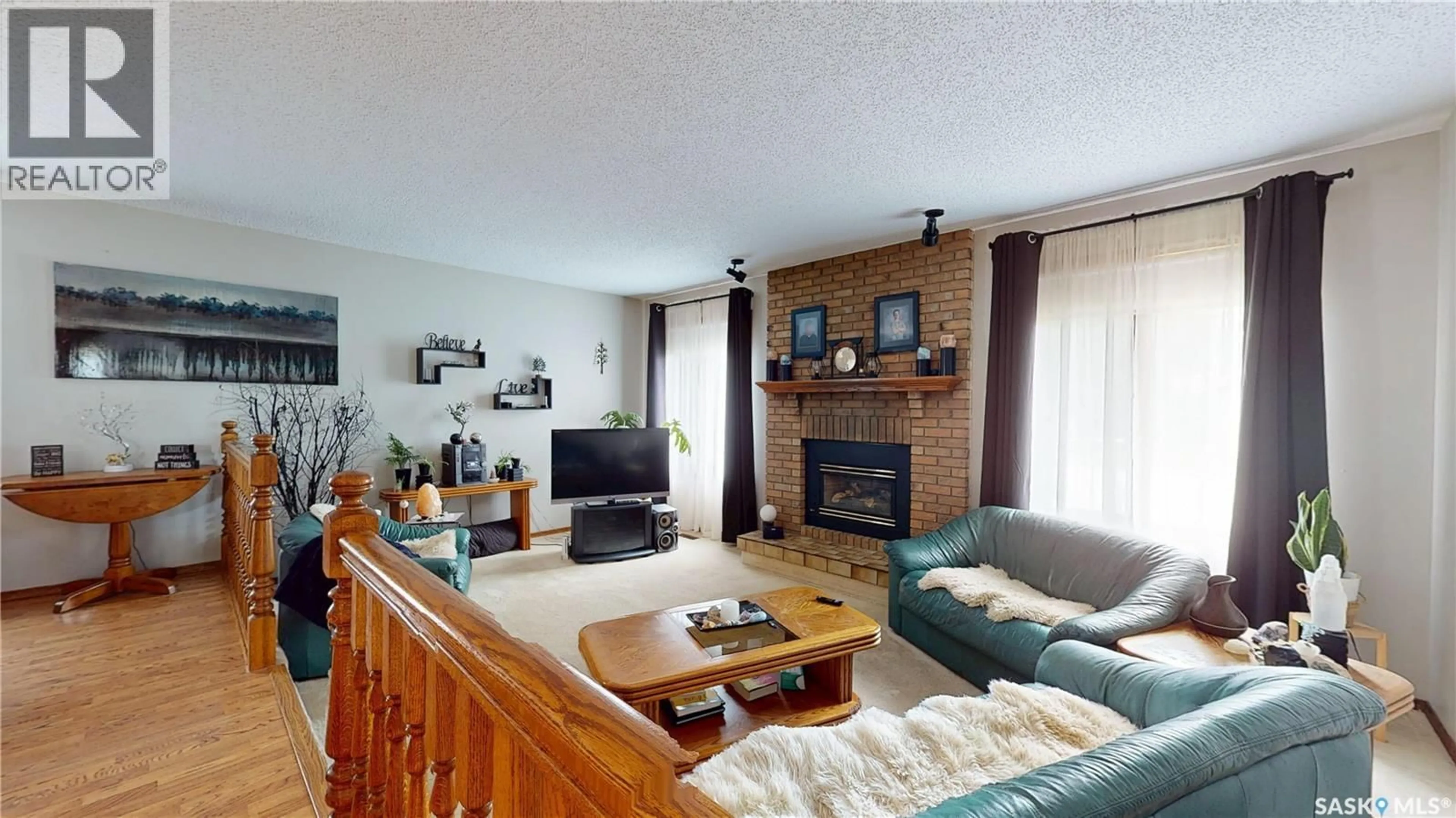 Living room with furniture, wood/laminate floor for 1358 LAKEWOOD CRESCENT, Regina Saskatchewan S4X3H3