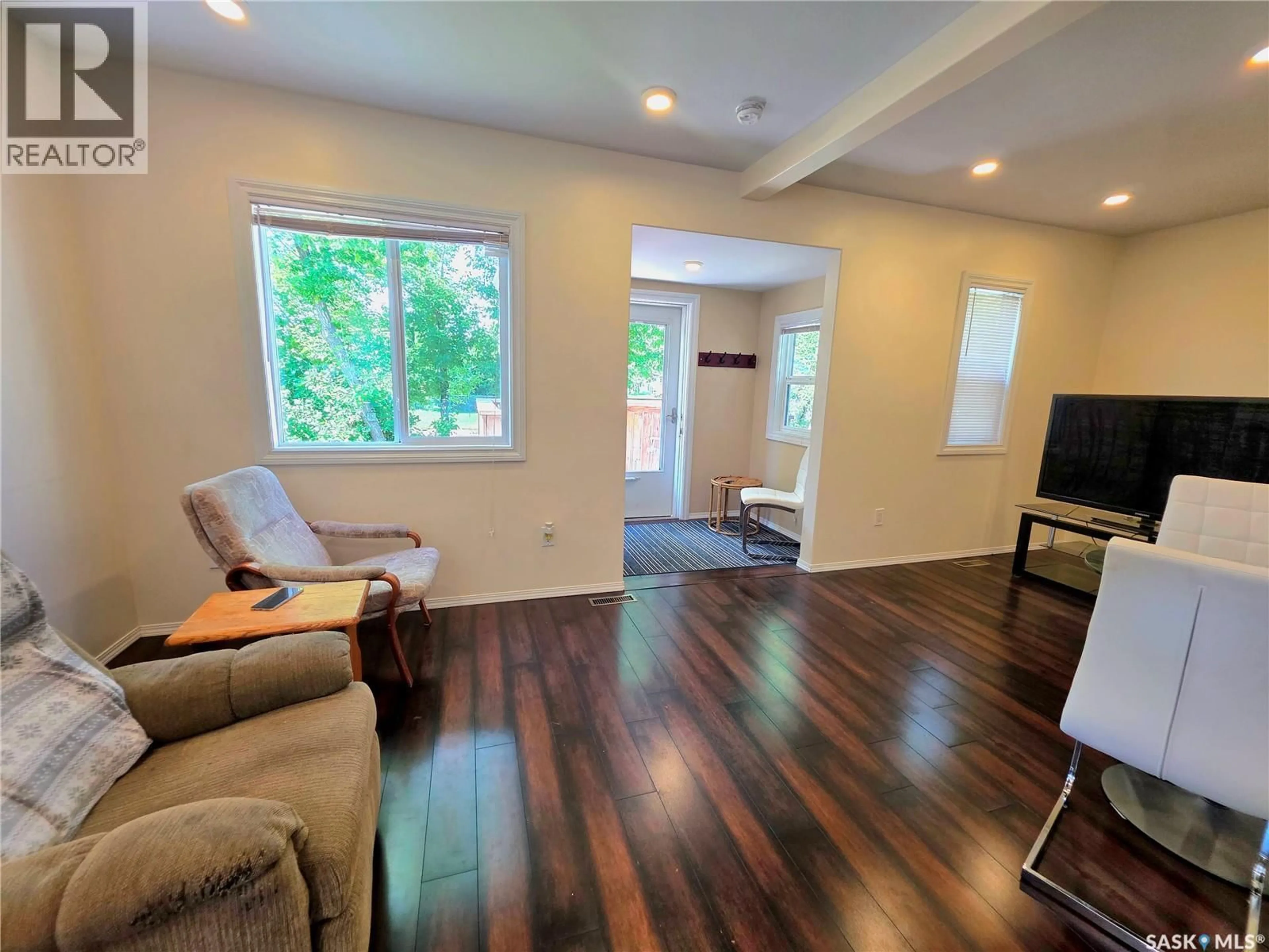 Living room with furniture, wood/laminate floor for 802 O AVENUE, Saskatoon Saskatchewan S7M2S7