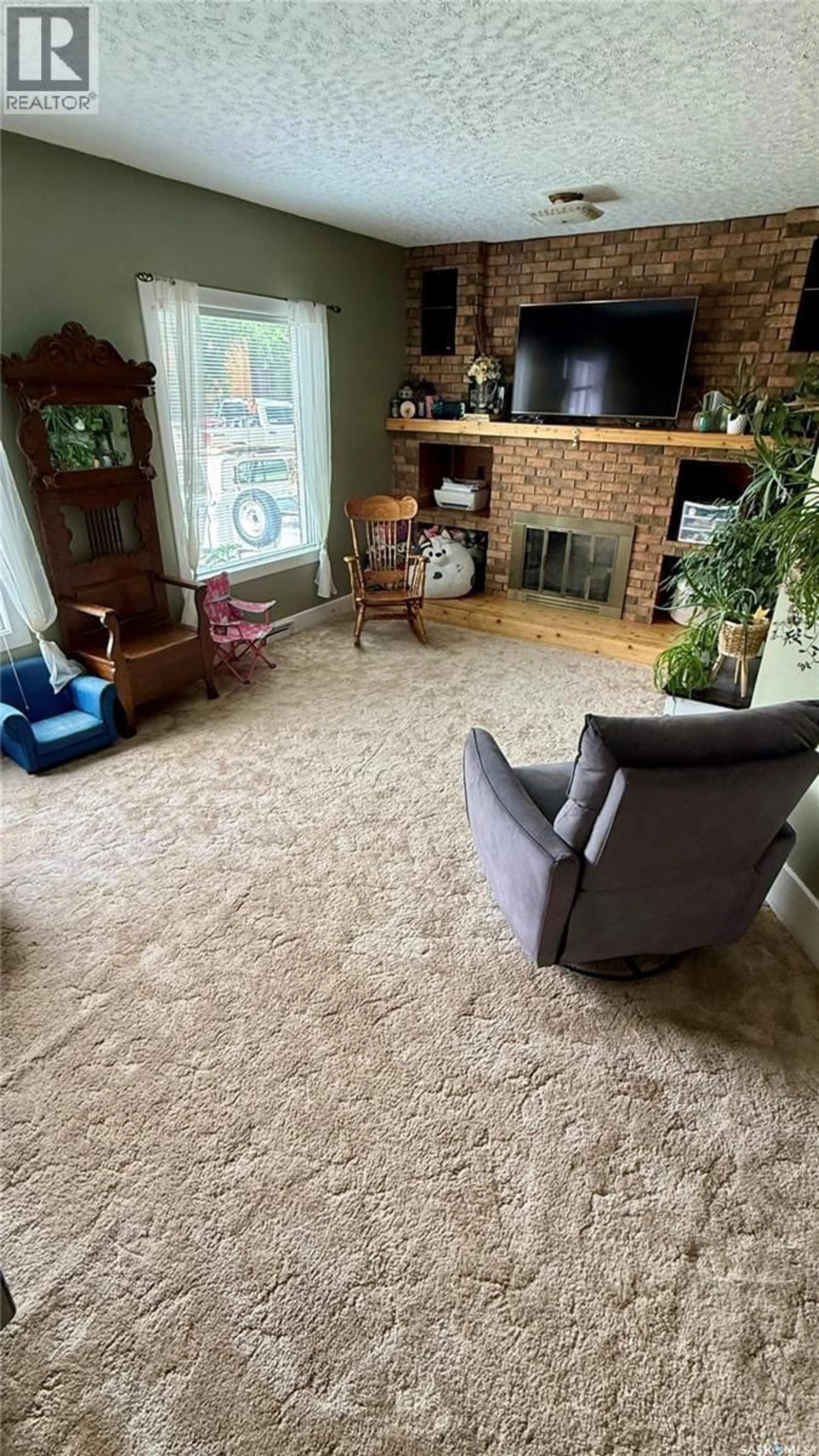 Living room with furniture, carpet floor for 1409 3RD STREET, Estevan Saskatchewan S4A0S3
