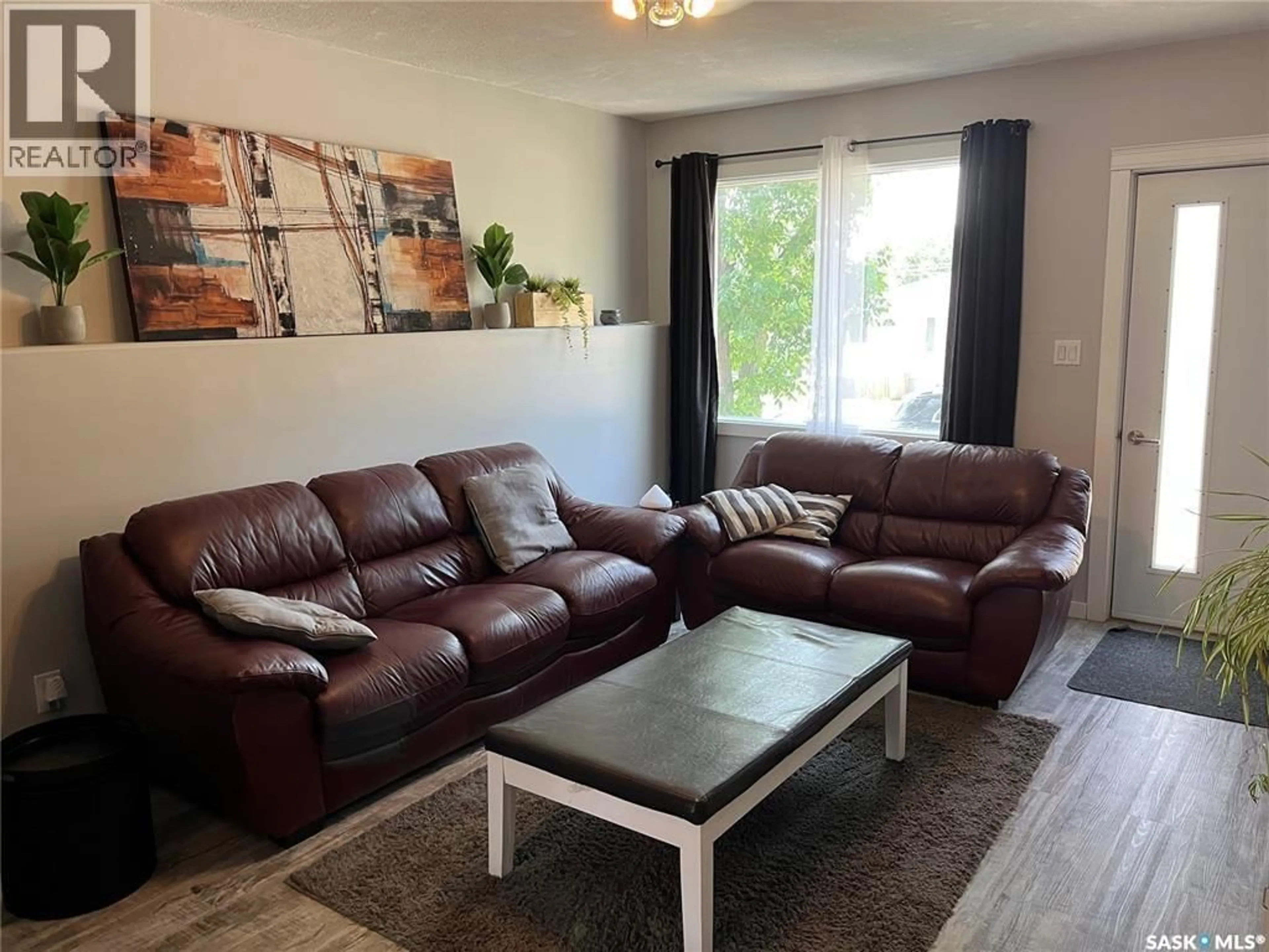 Living room with furniture, wood/laminate floor for 551 2ND AVENUE, Swift Current Saskatchewan S9H0R1