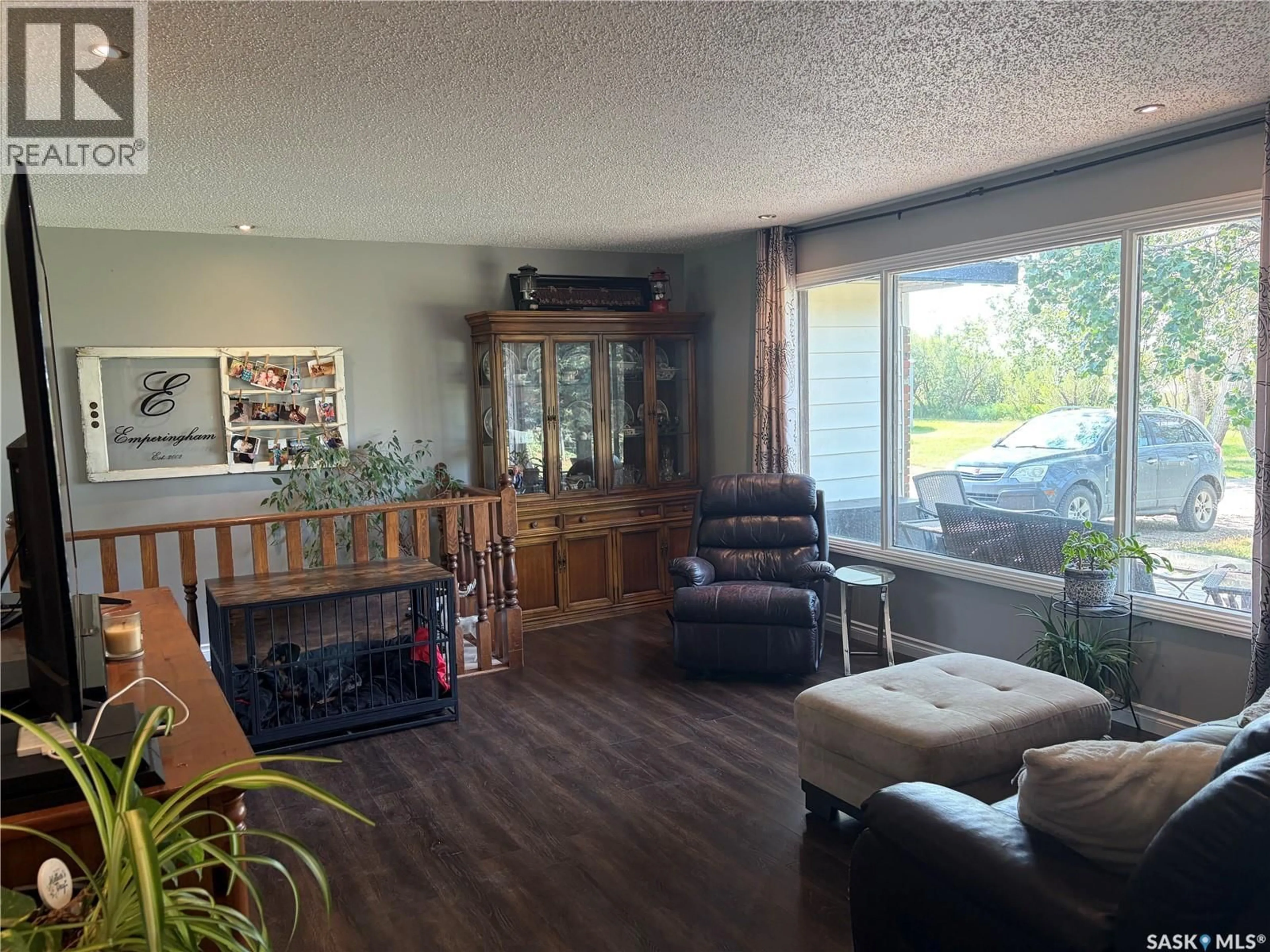 Living room with furniture, wood/laminate floor for EMPIRINGHAM ACREAGE, Coulee Rm No. 136 Saskatchewan S9H3X7