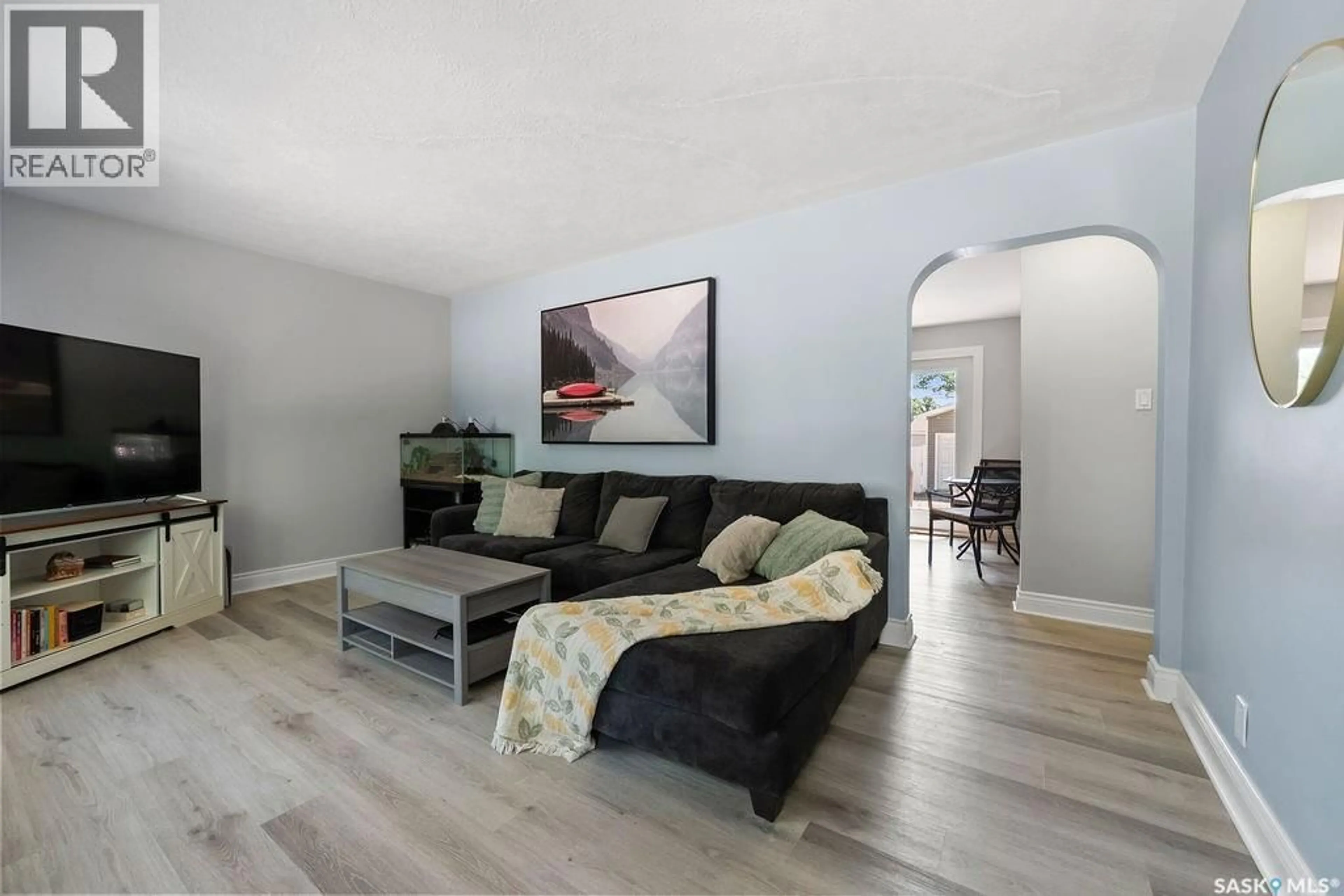 Living room with furniture, wood/laminate floor for 5309 1ST AVENUE, Regina Saskatchewan S4T0A7