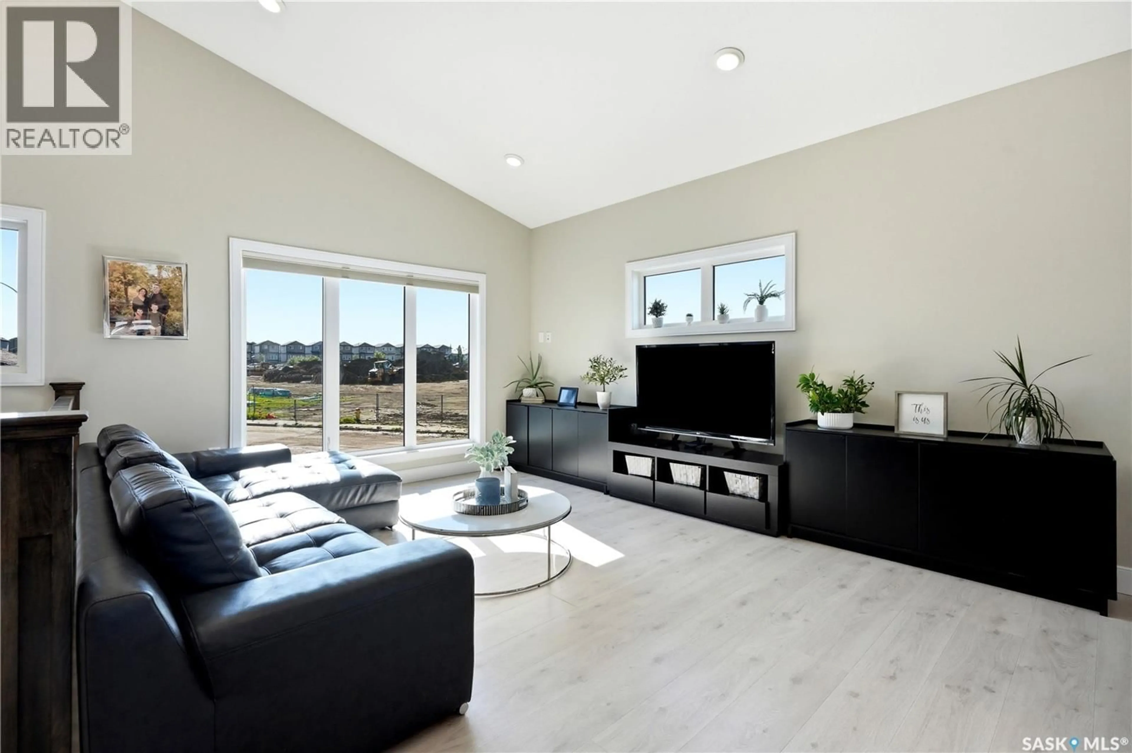 Living room with furniture, wood/laminate floor for 822 WERSCHNER COURT, Saskatoon Saskatchewan S7V0A7