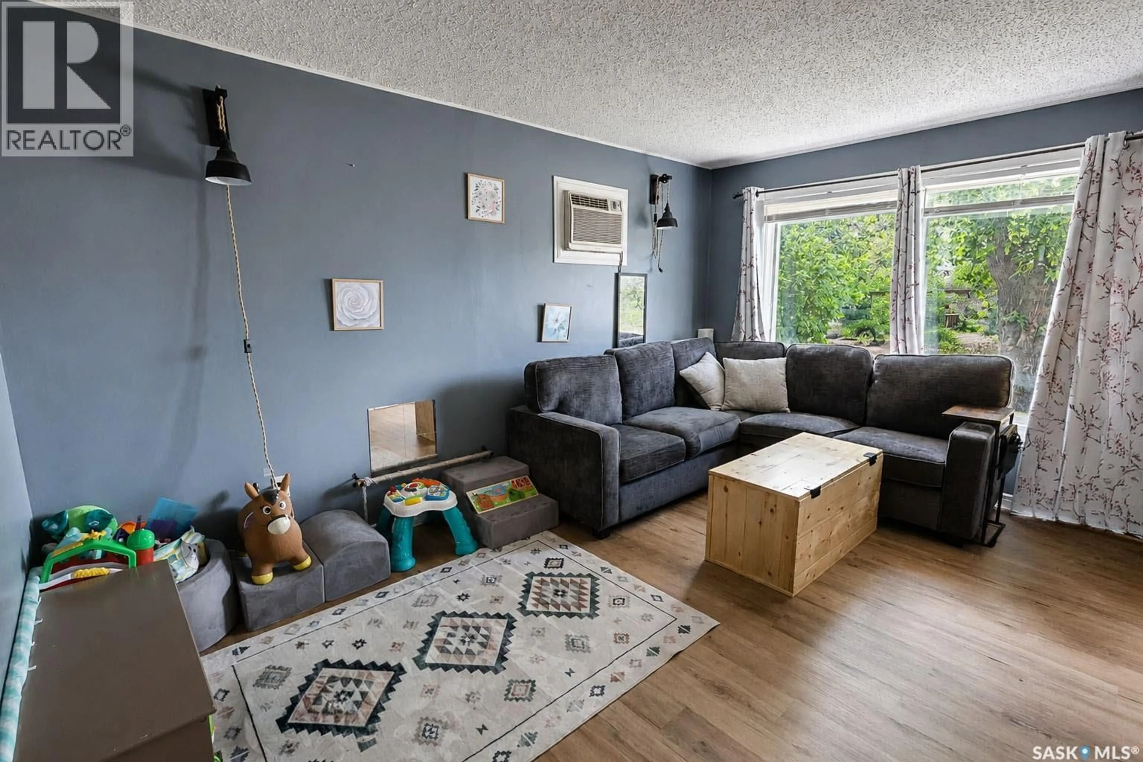 Living room with furniture, wood/laminate floor for 748 5TH STREET, Prince Albert Saskatchewan S6V0M5