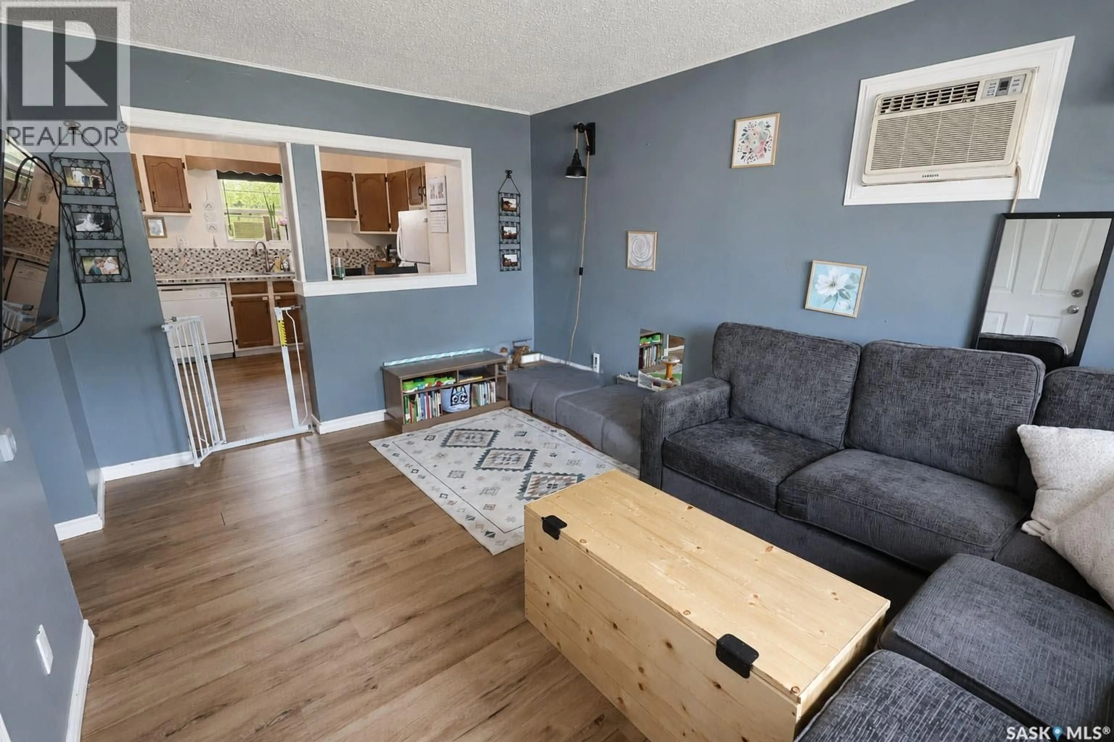 Living room with furniture, wood/laminate floor for 748 5TH STREET, Prince Albert Saskatchewan S6V0M5