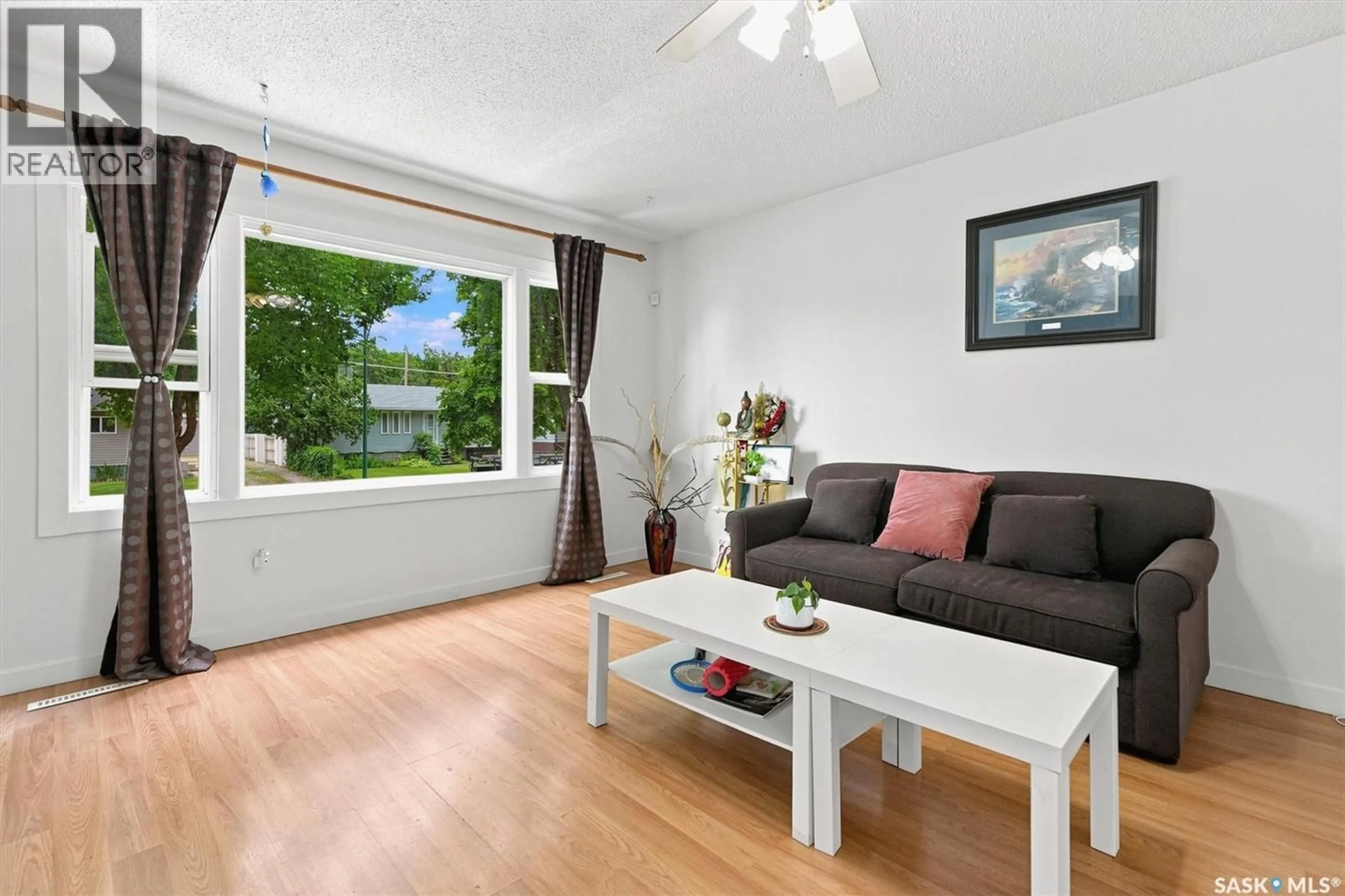 Living room with furniture, wood/laminate floor for 1709 2ND AVENUE, Saskatoon Saskatchewan S7K3N2