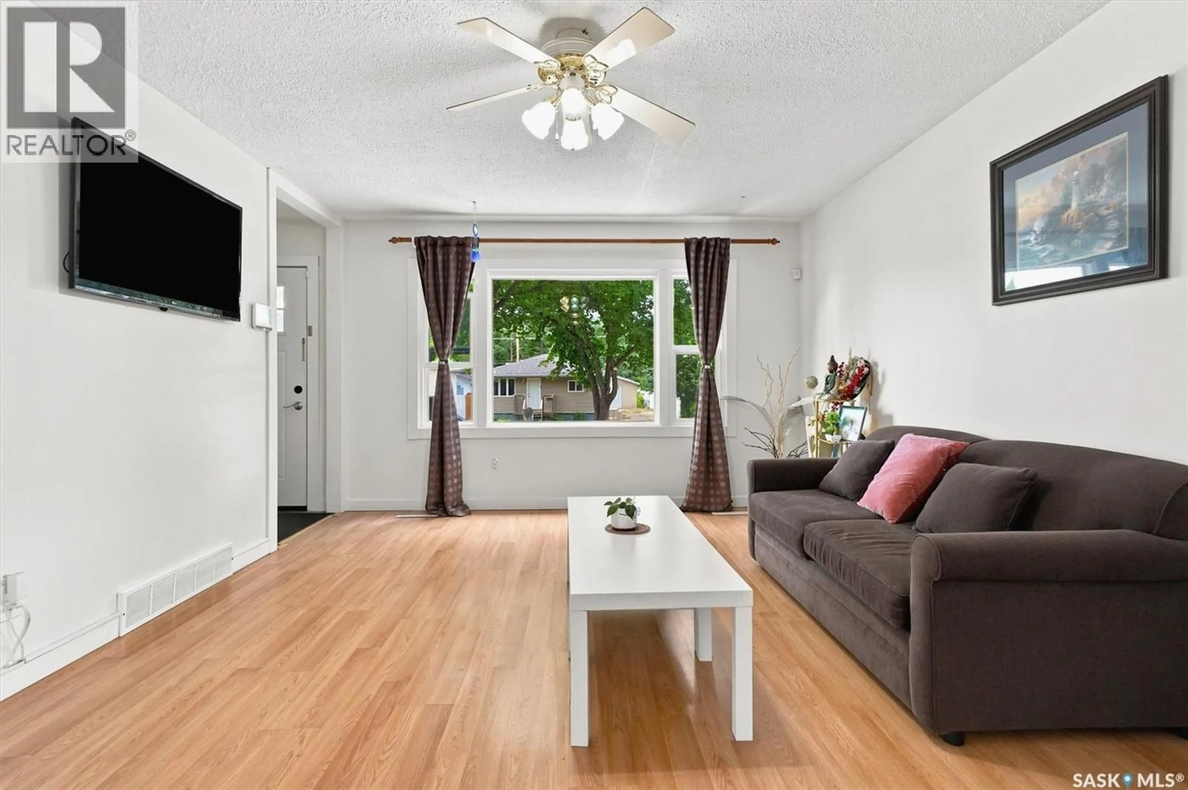 Living room with furniture, wood/laminate floor for 1709 2ND AVENUE, Saskatoon Saskatchewan S7K3N2