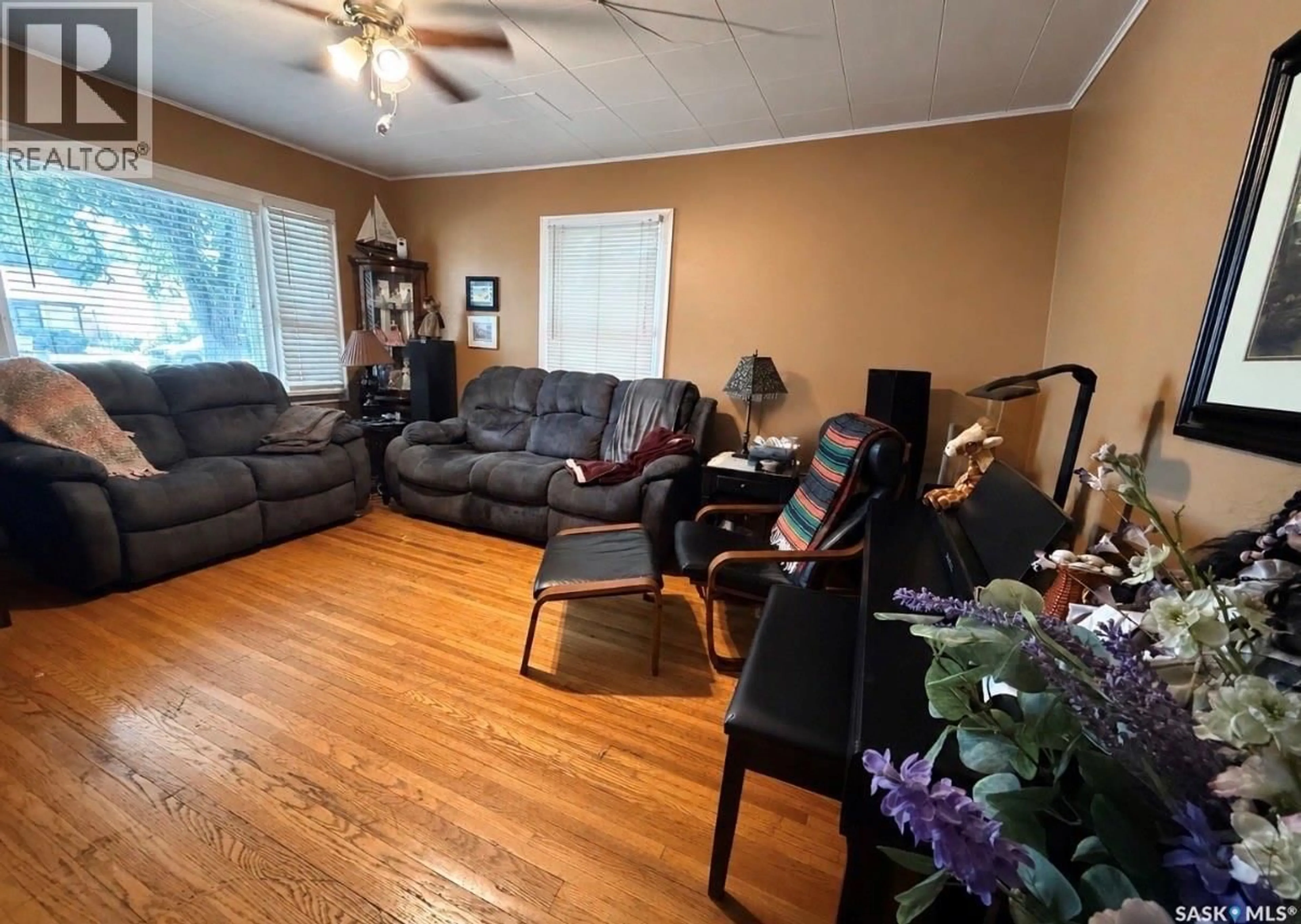 Living room with furniture, wood/laminate floor for 334 6TH AVENUE, Swift Current Saskatchewan S9H3P1