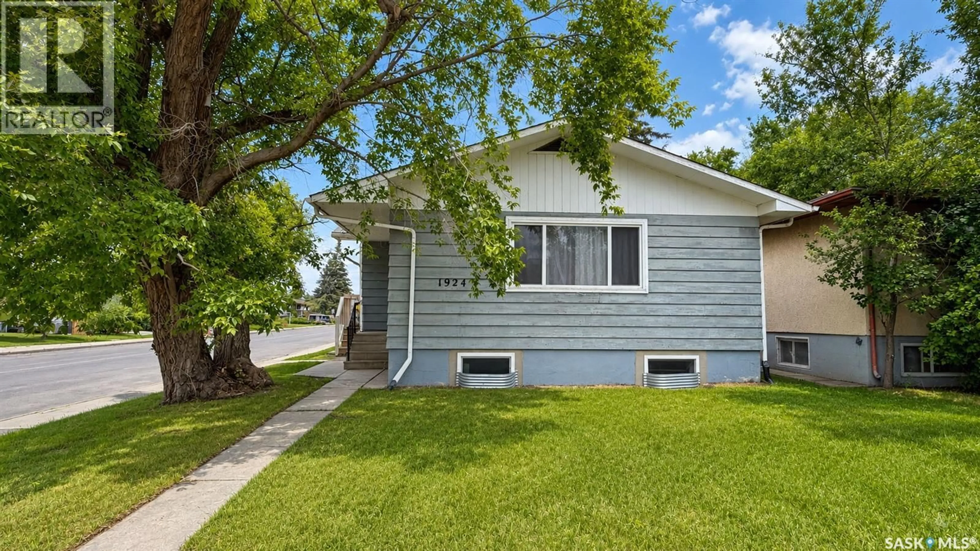 Home with vinyl exterior material, street for 1924 22ND STREET, Saskatoon Saskatchewan S7M0T9