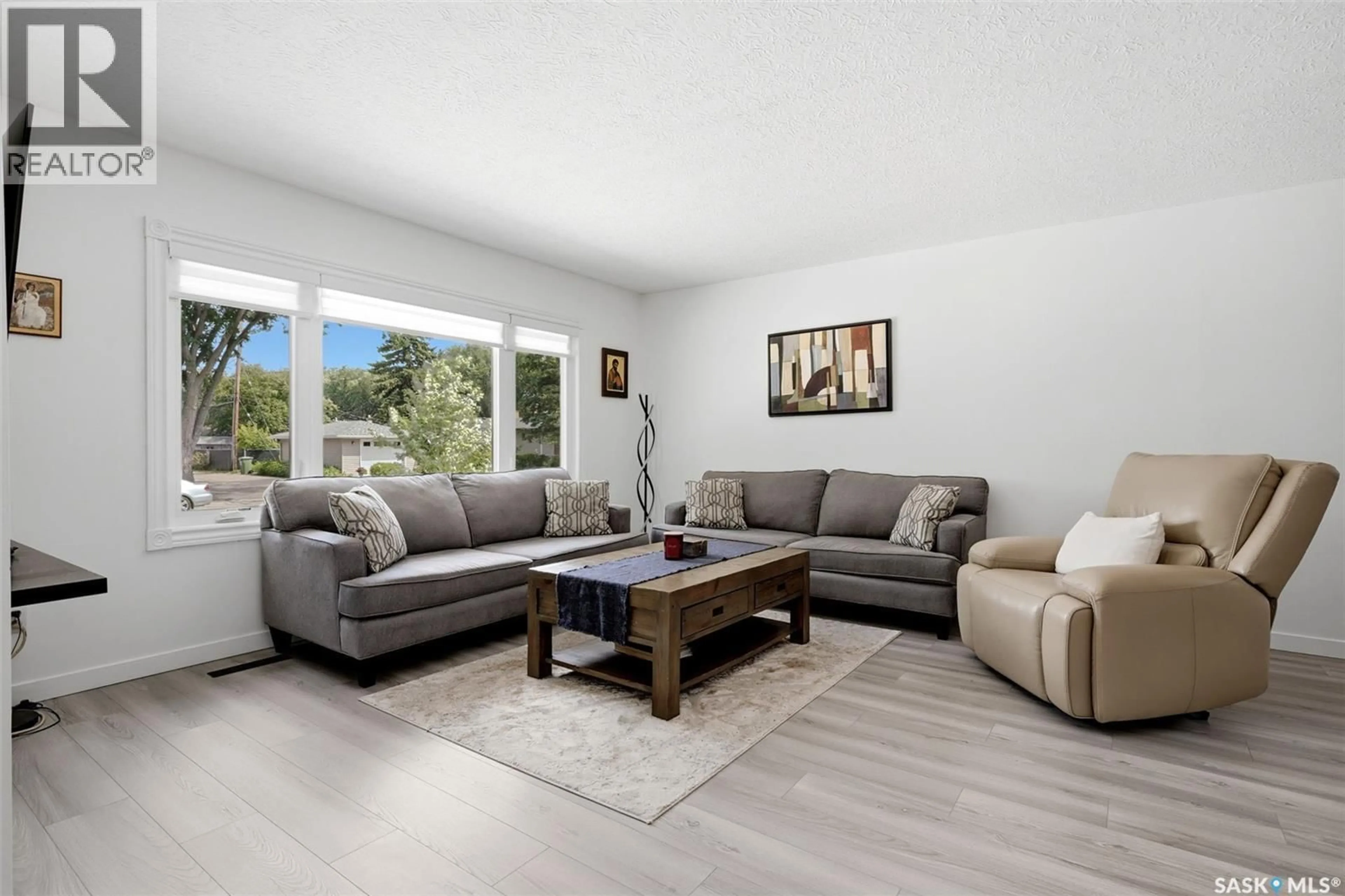 Living room with furniture, wood/laminate floor for 4064 MONTAGUE STREET, Regina Saskatchewan S4S3K2