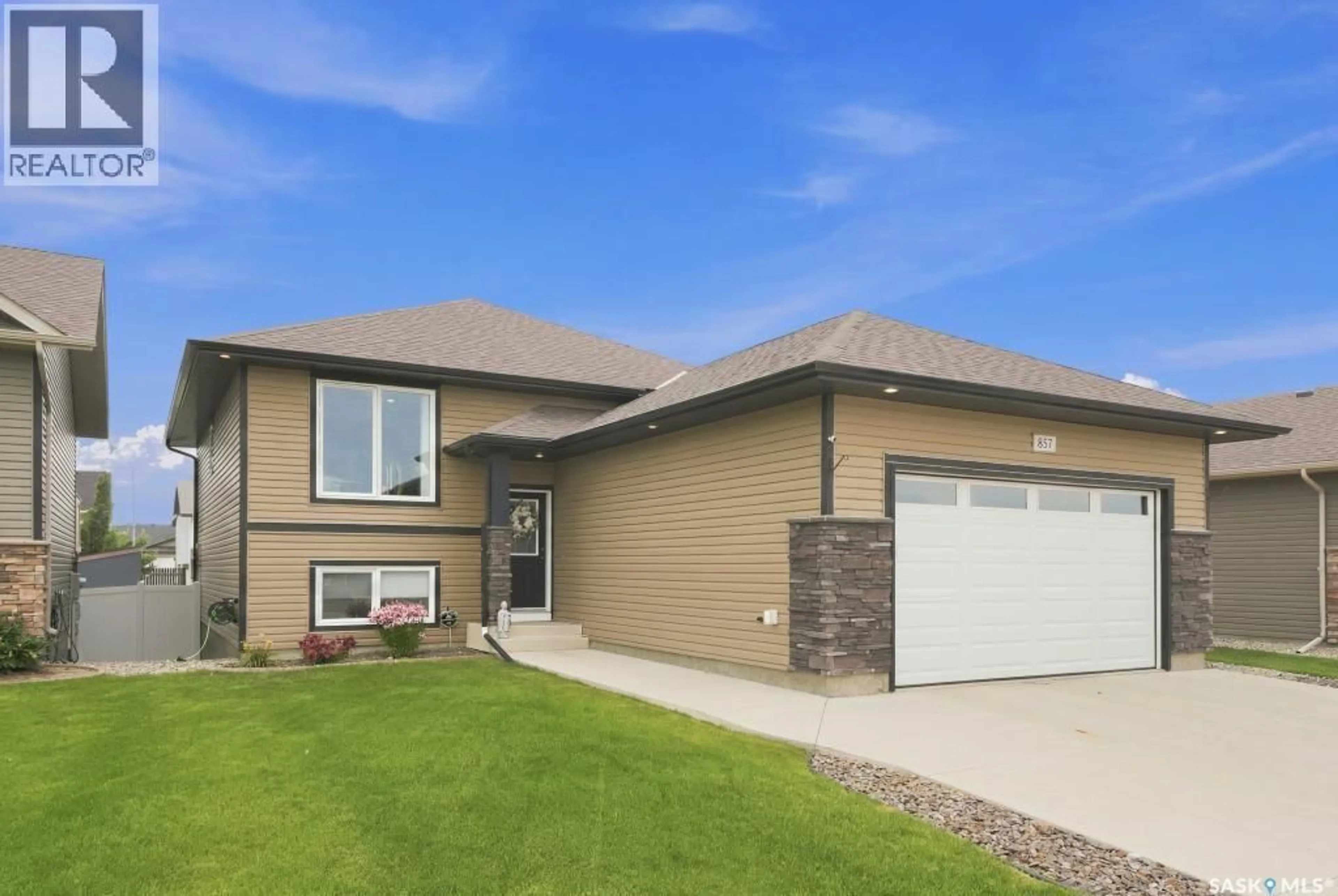 Home with vinyl exterior material, street for 857 REIMER ROAD, Martensville Saskatchewan S0K0A2