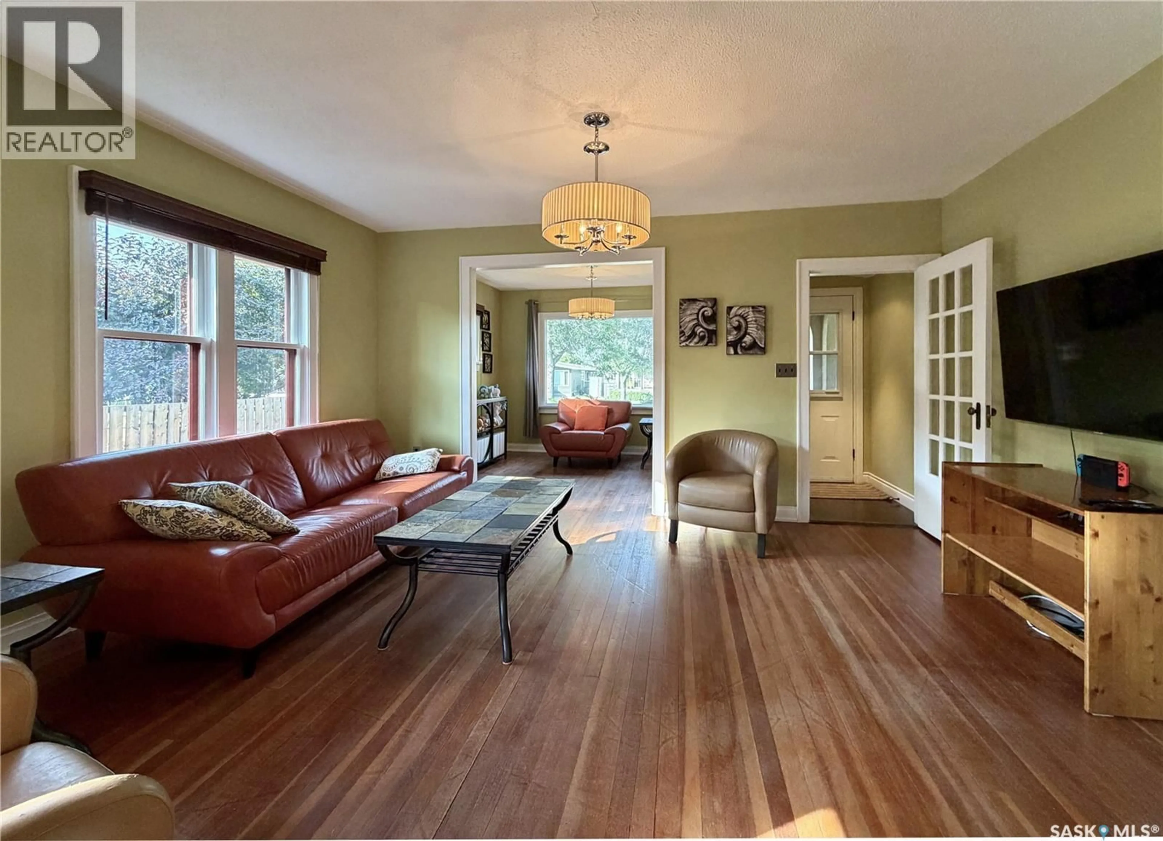 Living room with furniture, wood/laminate floor for 1305 2ND STREET, Estevan Saskatchewan S4A0M3