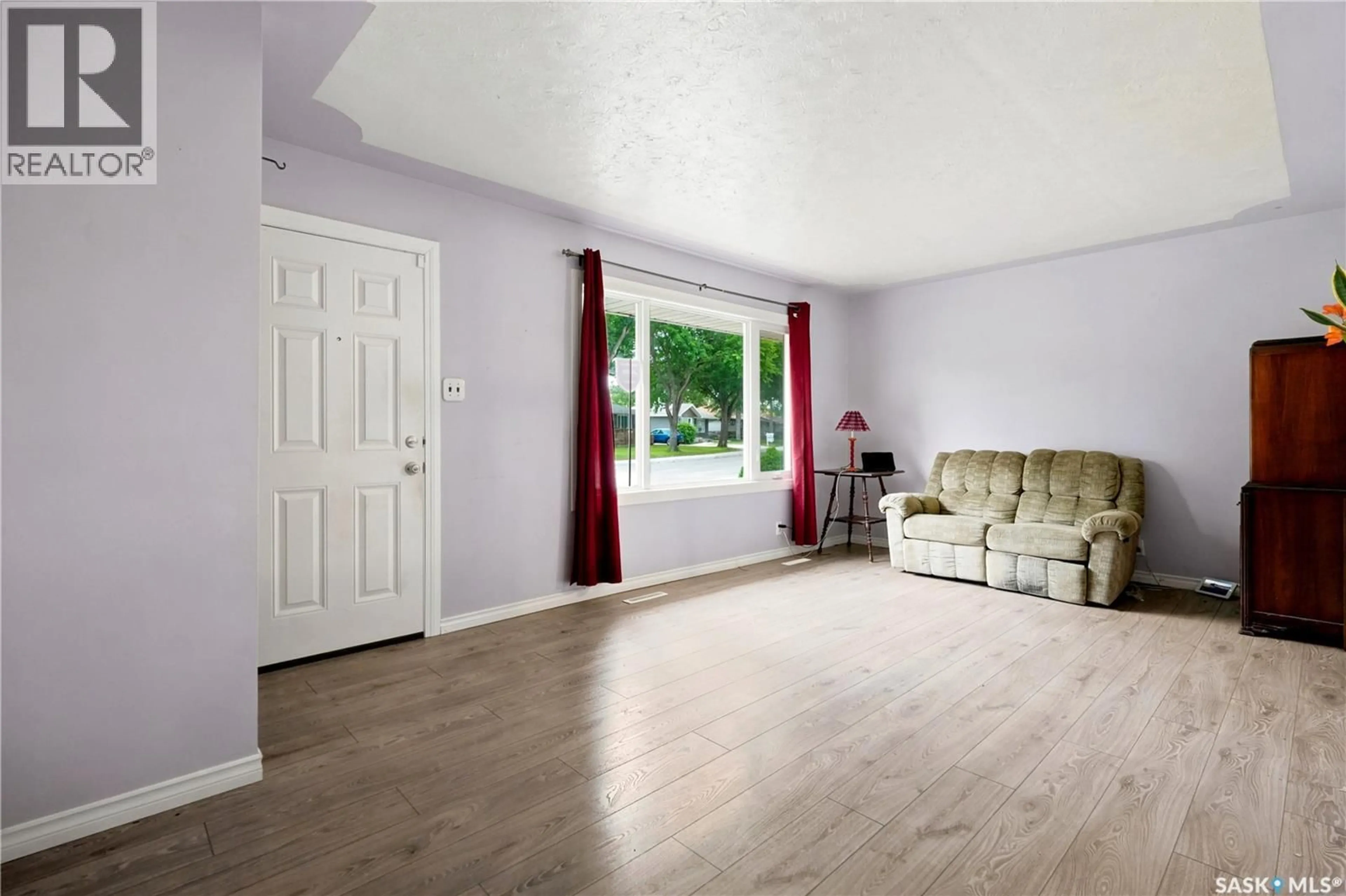 Living room with furniture, wood/laminate floor for 145 ELLISON CRESCENT, Regina Saskatchewan S4R4V6