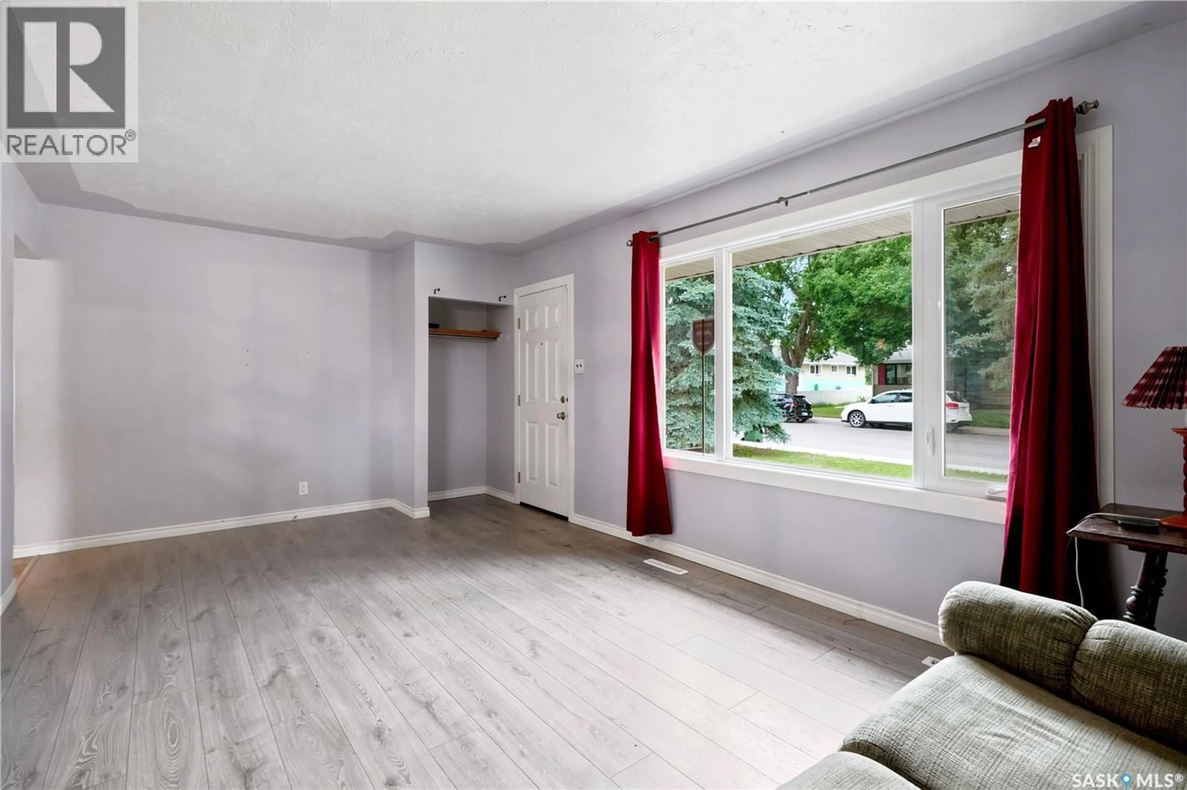 Living room with furniture, wood/laminate floor for 145 ELLISON CRESCENT, Regina Saskatchewan S4R4V6