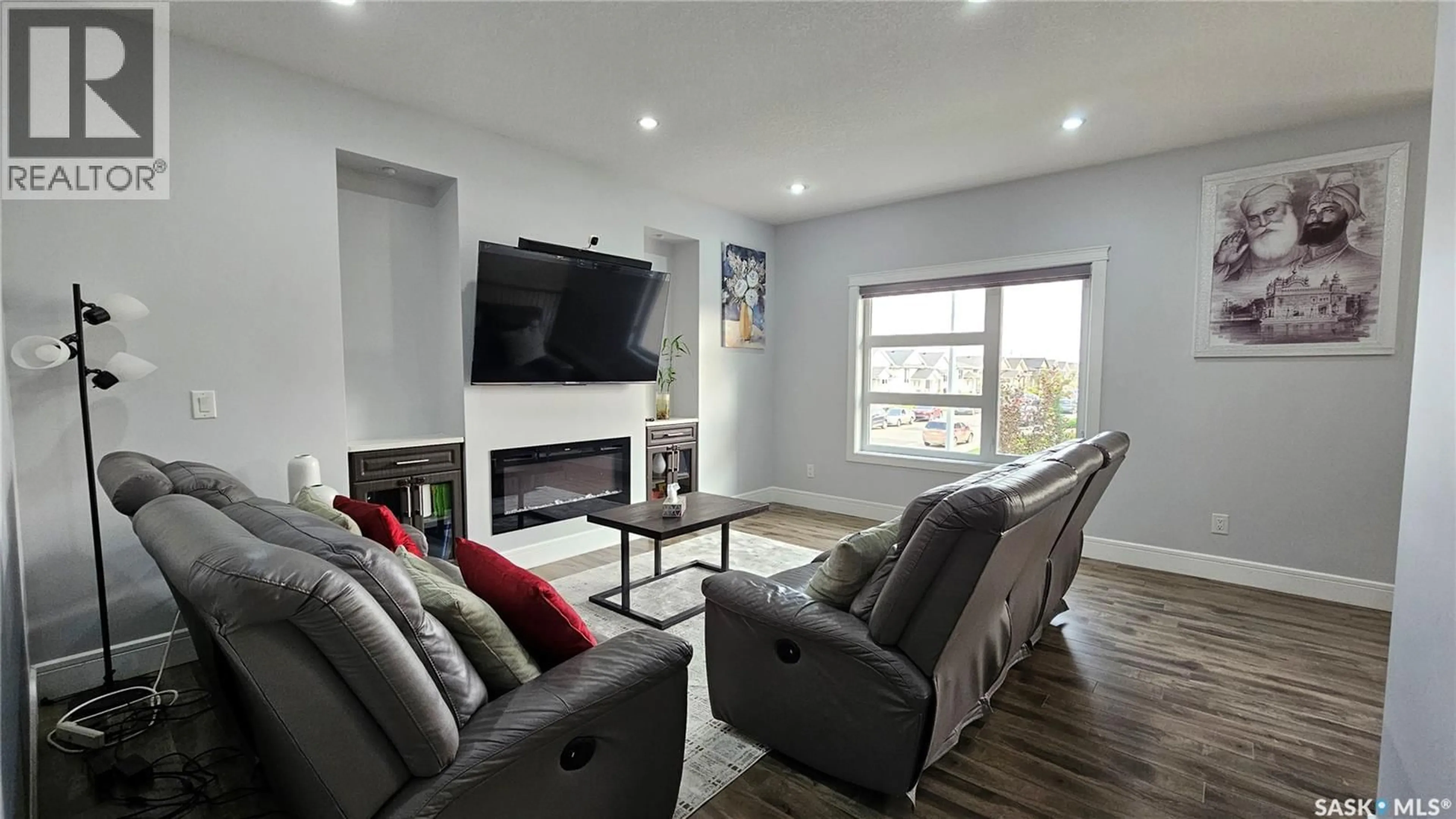 Living room with furniture, wood/laminate floor for 126 BOLSTAD WAY, Saskatoon Saskatchewan S7W0Y1