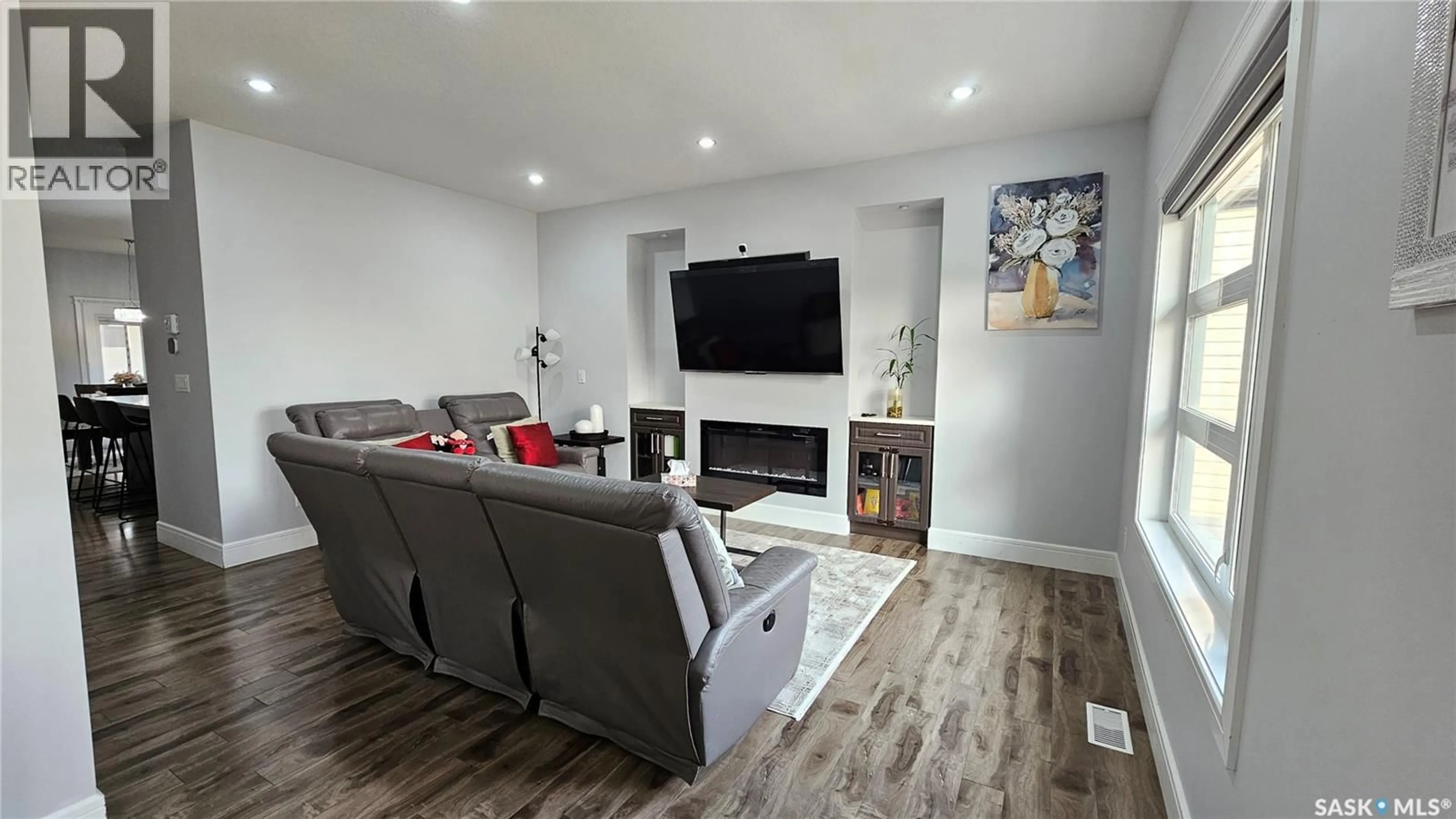 Living room with furniture, wood/laminate floor for 126 BOLSTAD WAY, Saskatoon Saskatchewan S7W0Y1