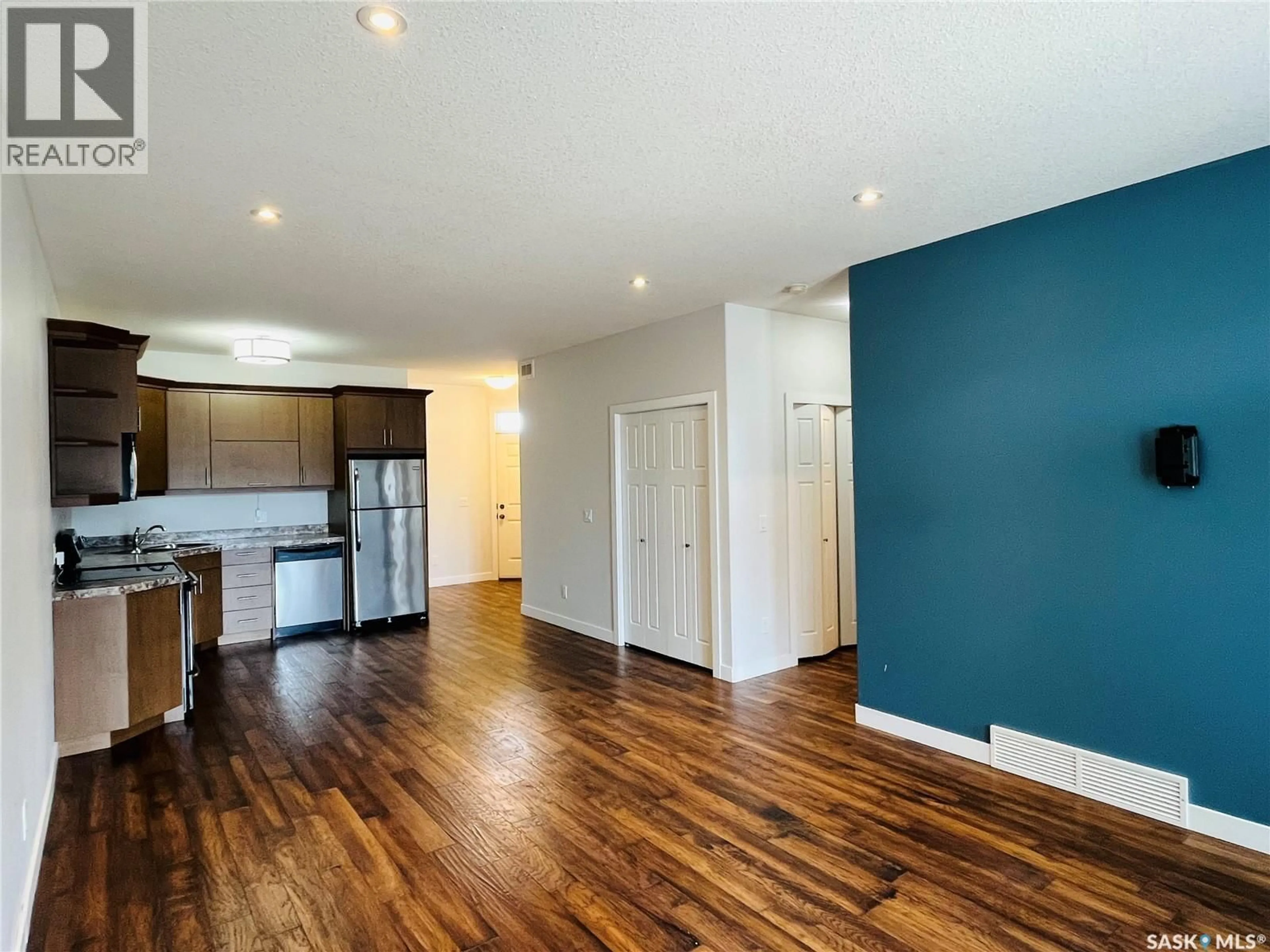 Open concept kitchen, wood/laminate floor for E - 4217 GREEN APPLE DRIVE, Regina Saskatchewan S4V1S1